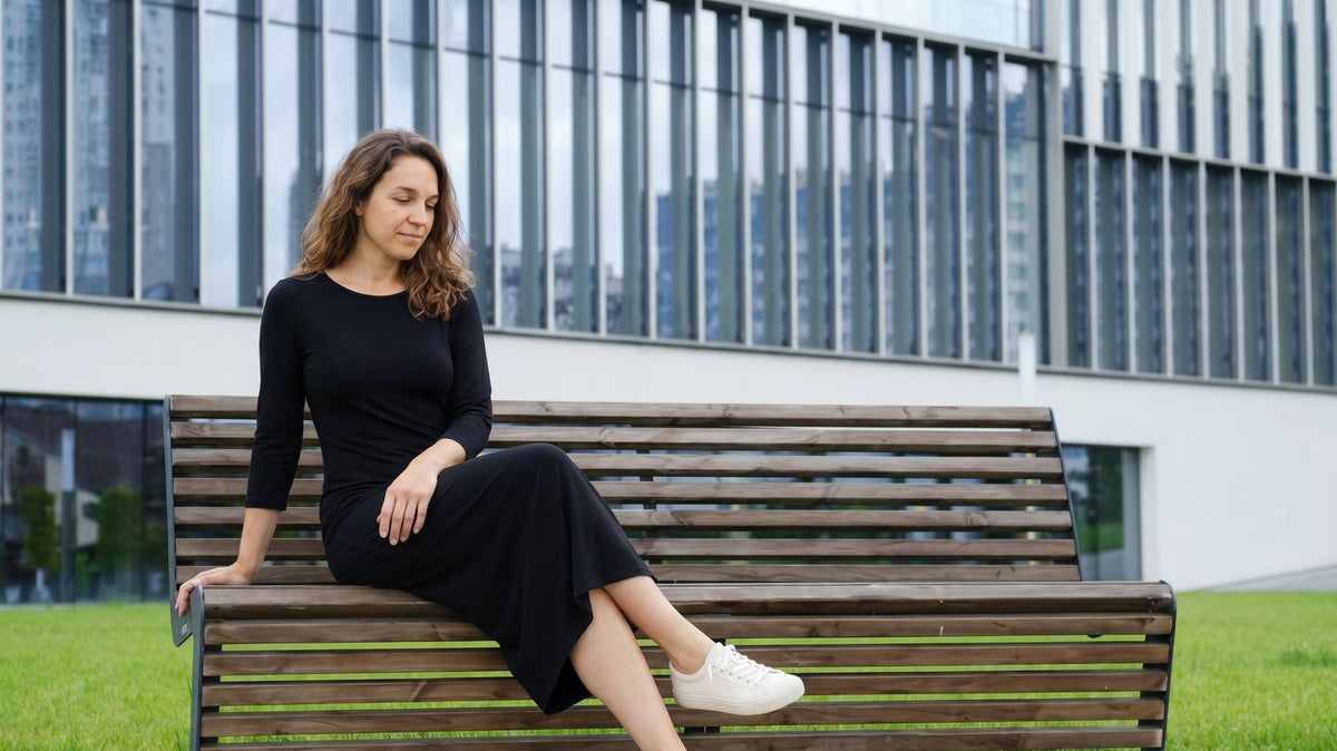 Woman wearing the Nuggles Original Midi Layering Dress in Black, a modest 46 inch cotton midi dress