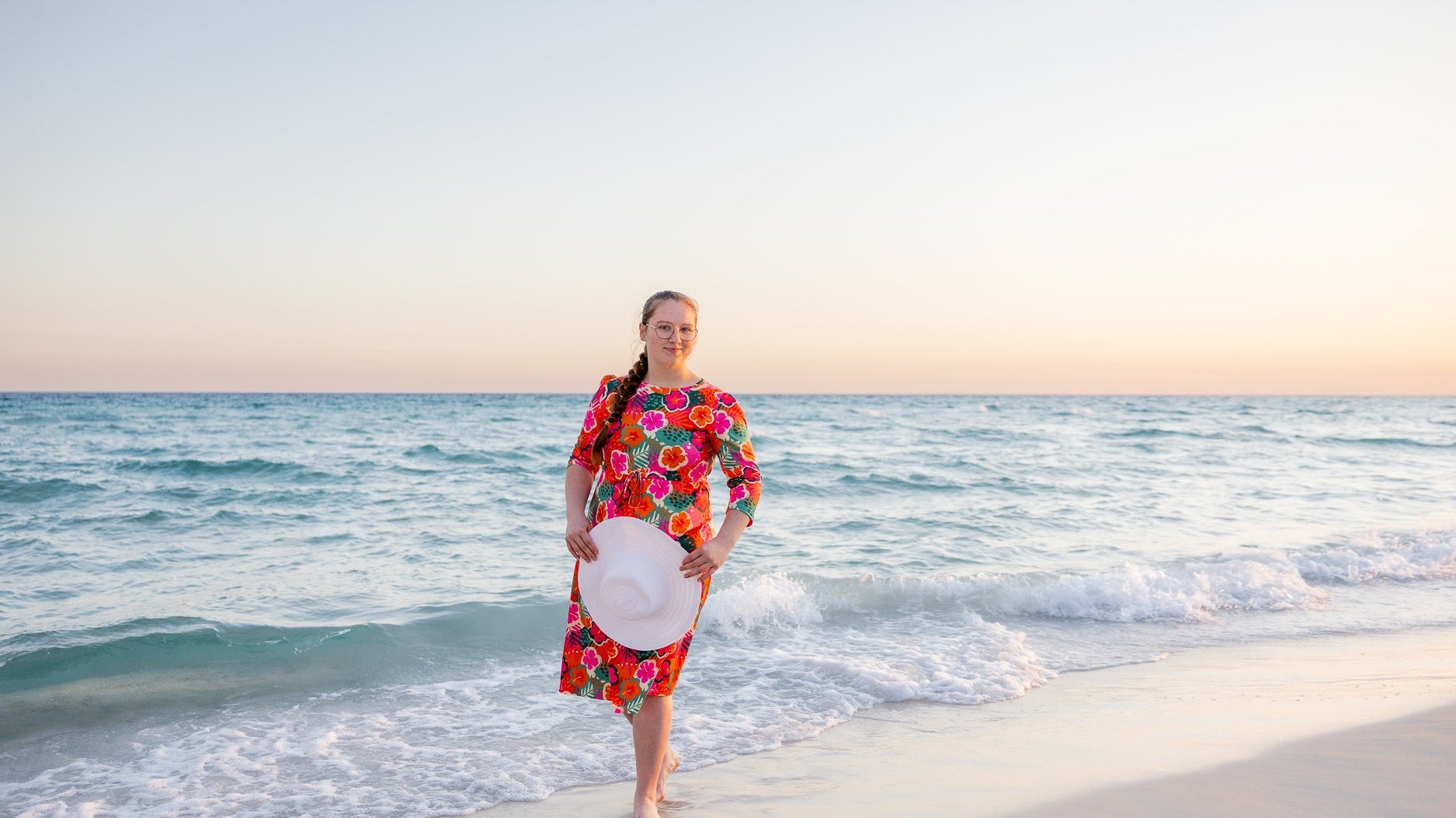 A women at the beach wearing a modest sport swim dress.