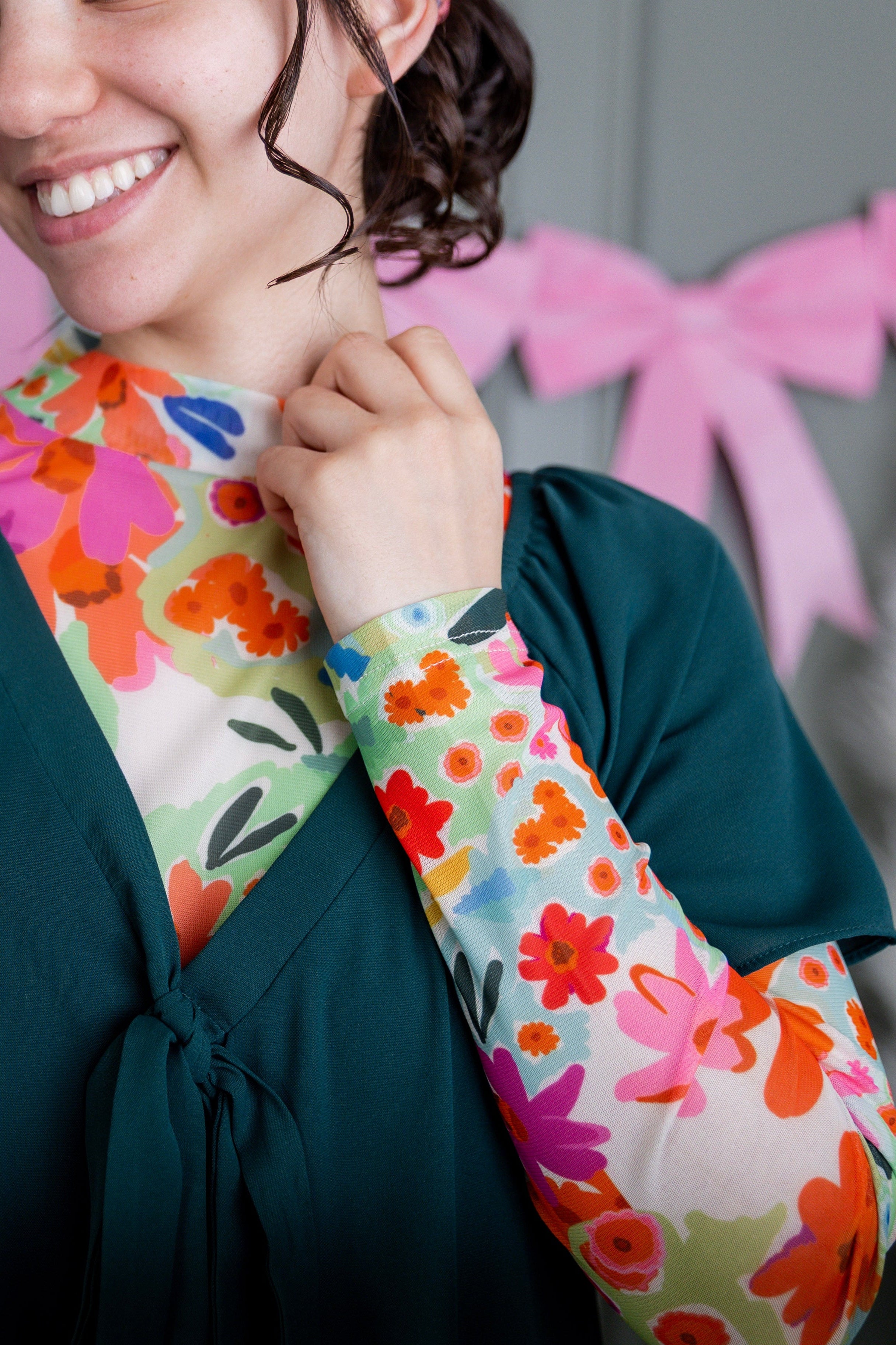 A women wearing our modest Keegan Top in black and white holding red hearts.