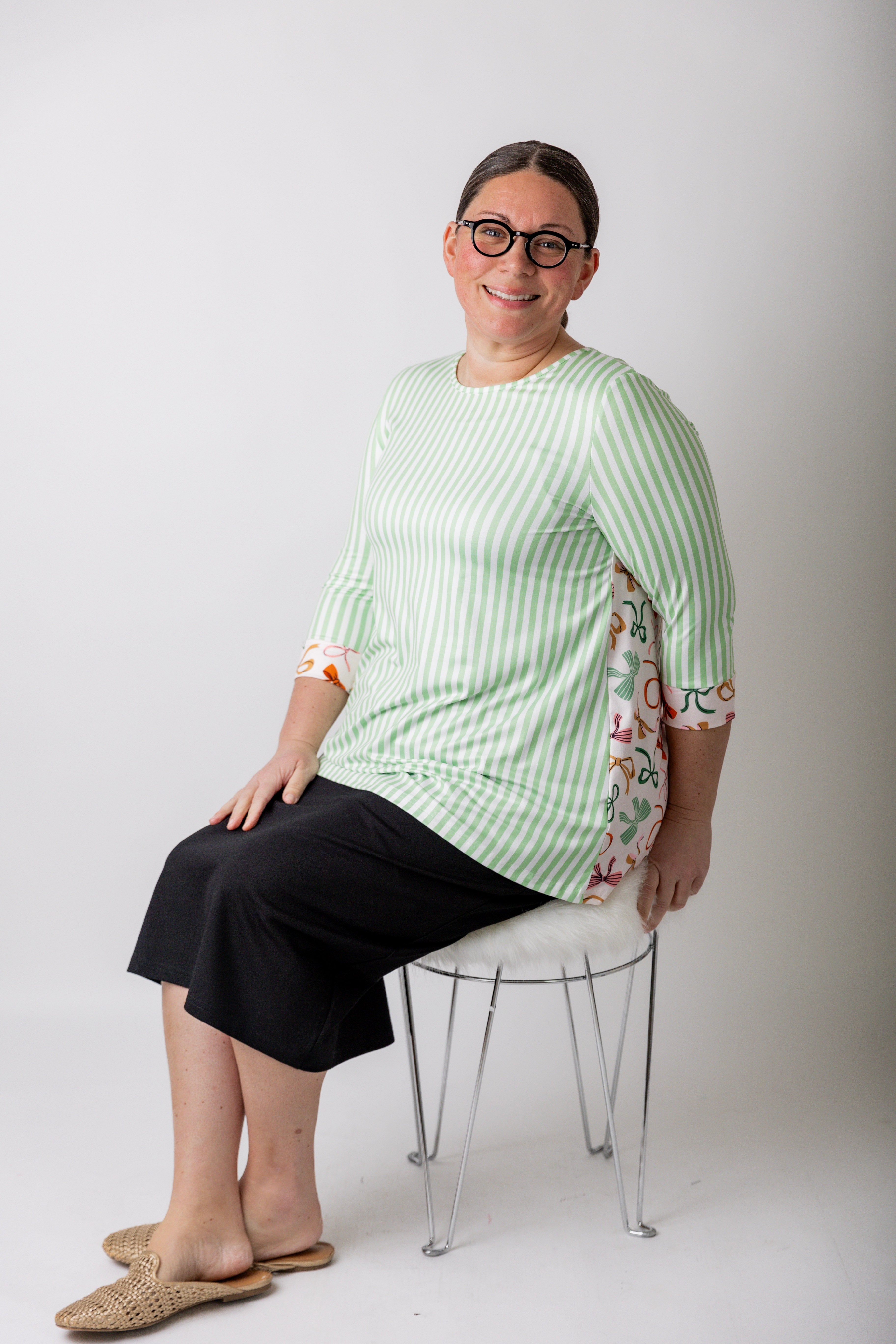 Women wearing a modest top and black pencil skirt from Nuggles that are available in plus sizes.