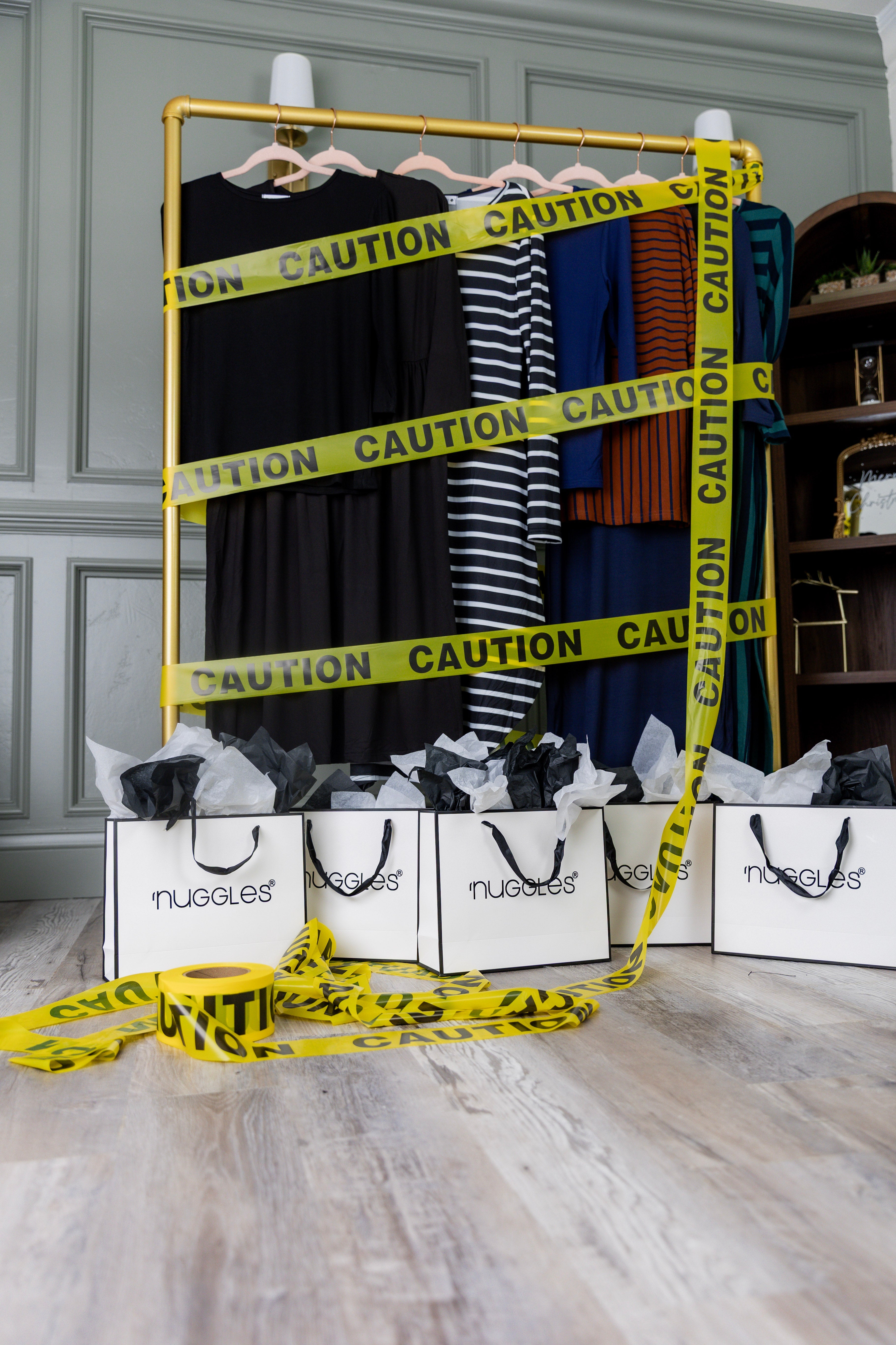 A gold rack featuring some of our Nuggles® products wrapped in caution tape.