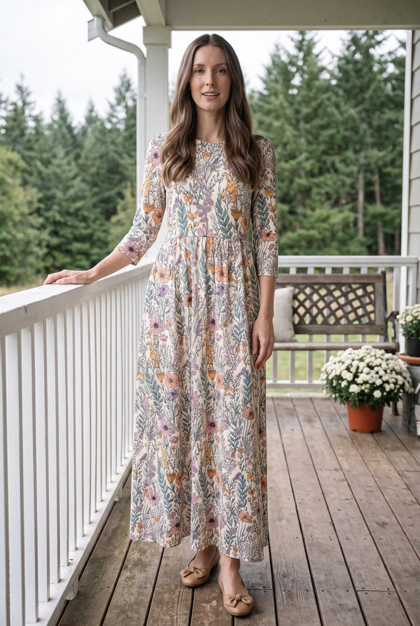 Nuggles® Cleo Maxi Dress in Hedgerow, full length facing the camera with one arm resting on the porch rail
