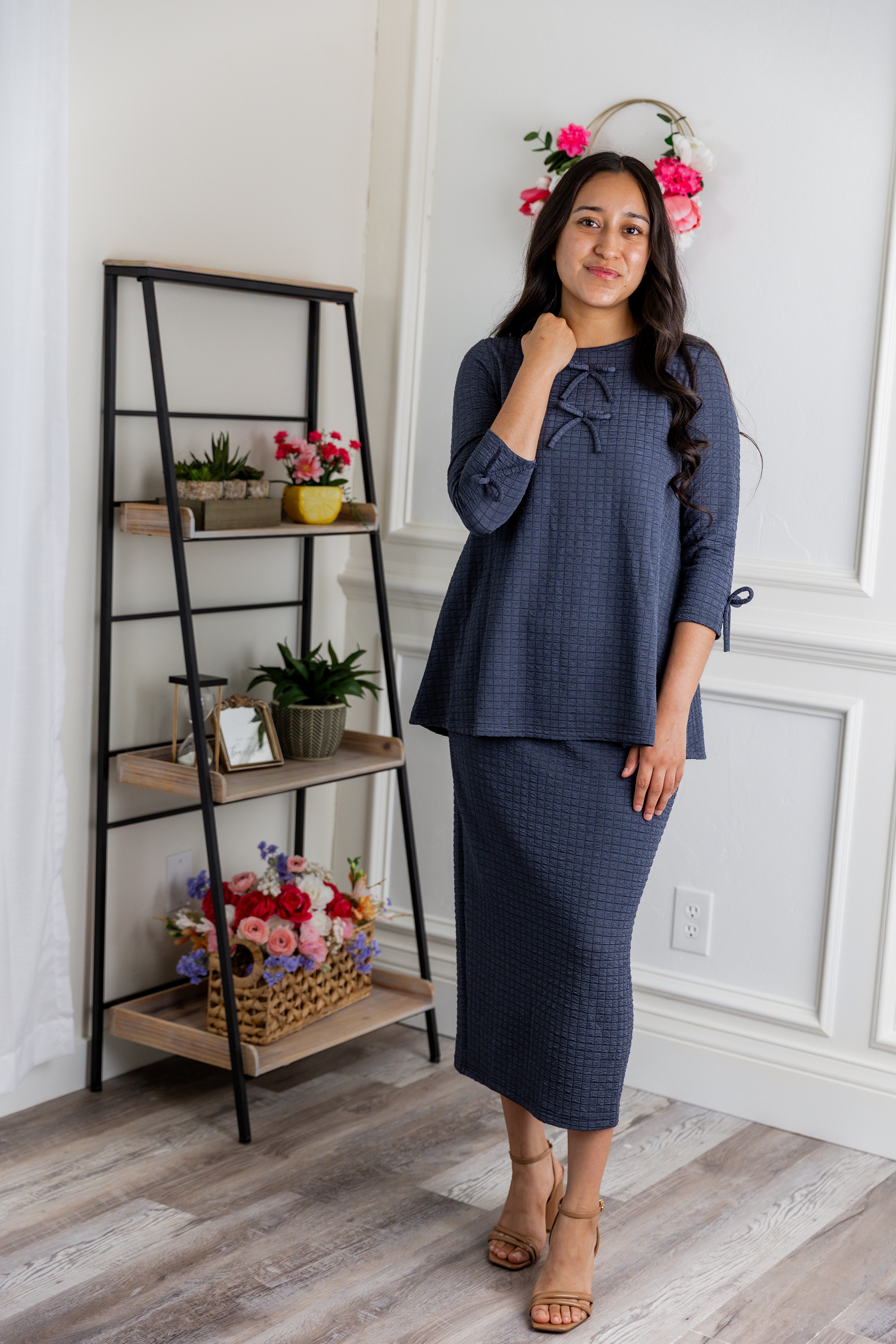 A women wearing the matching Lexi Top and Skirt in a beautiful gray color.