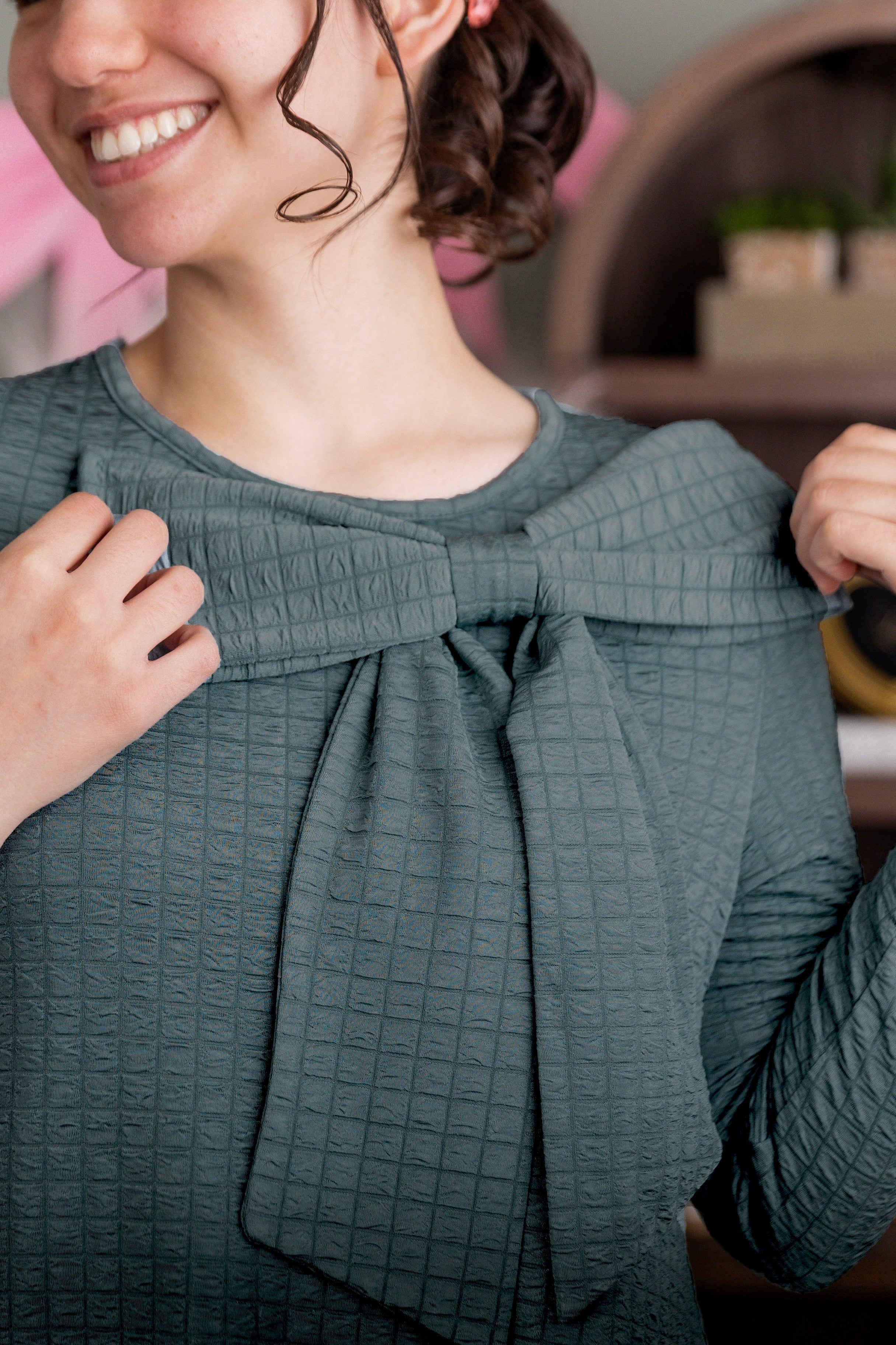 The Ladies Green Eleanor Top with a bow.