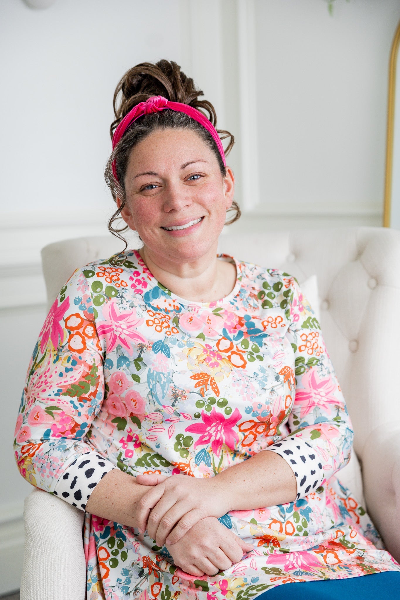 Woman wearing a modest top with full coverage that is nursing friendly.