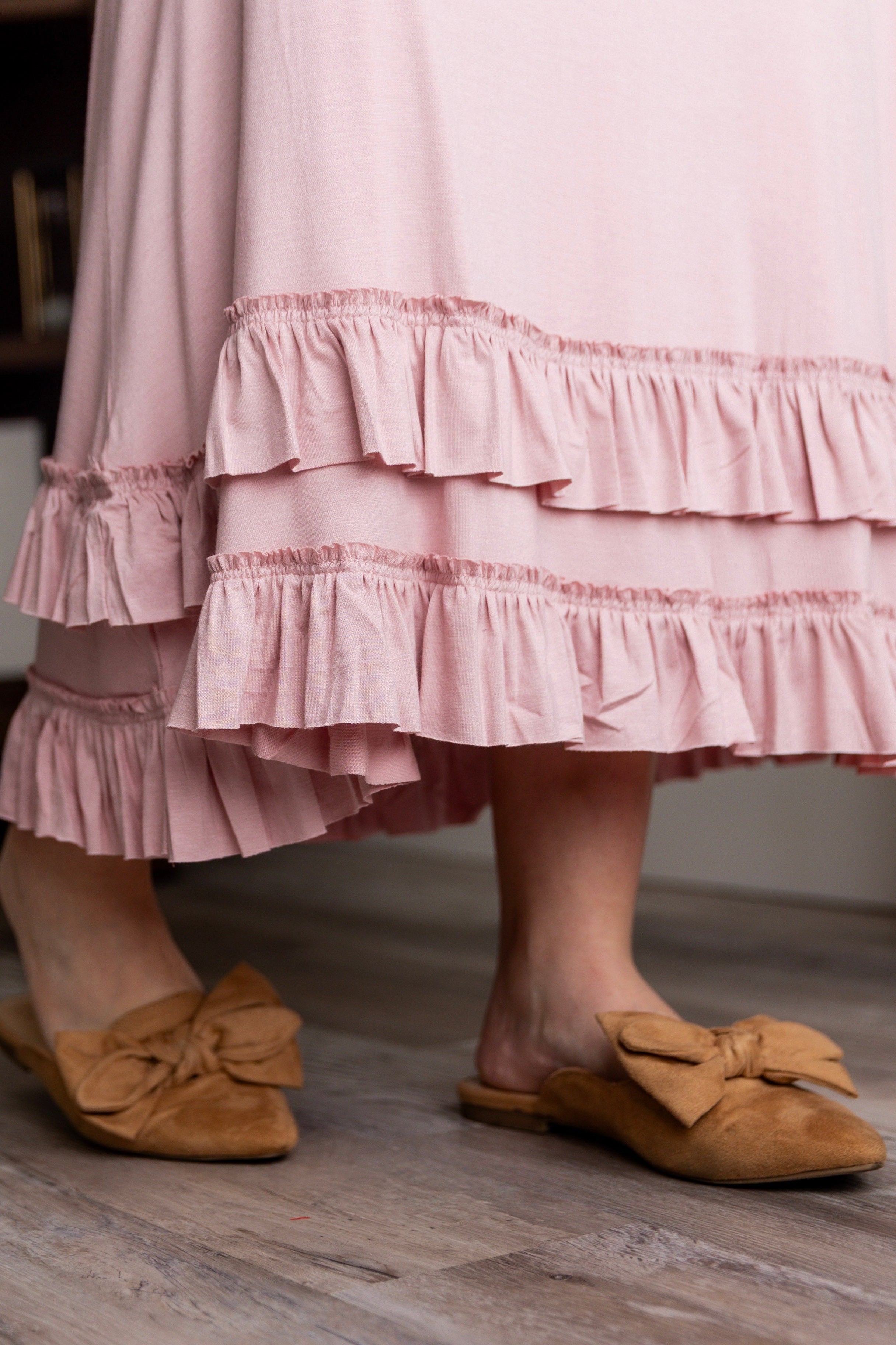 A detail picture of a modest maxi skirt with two ruffles.