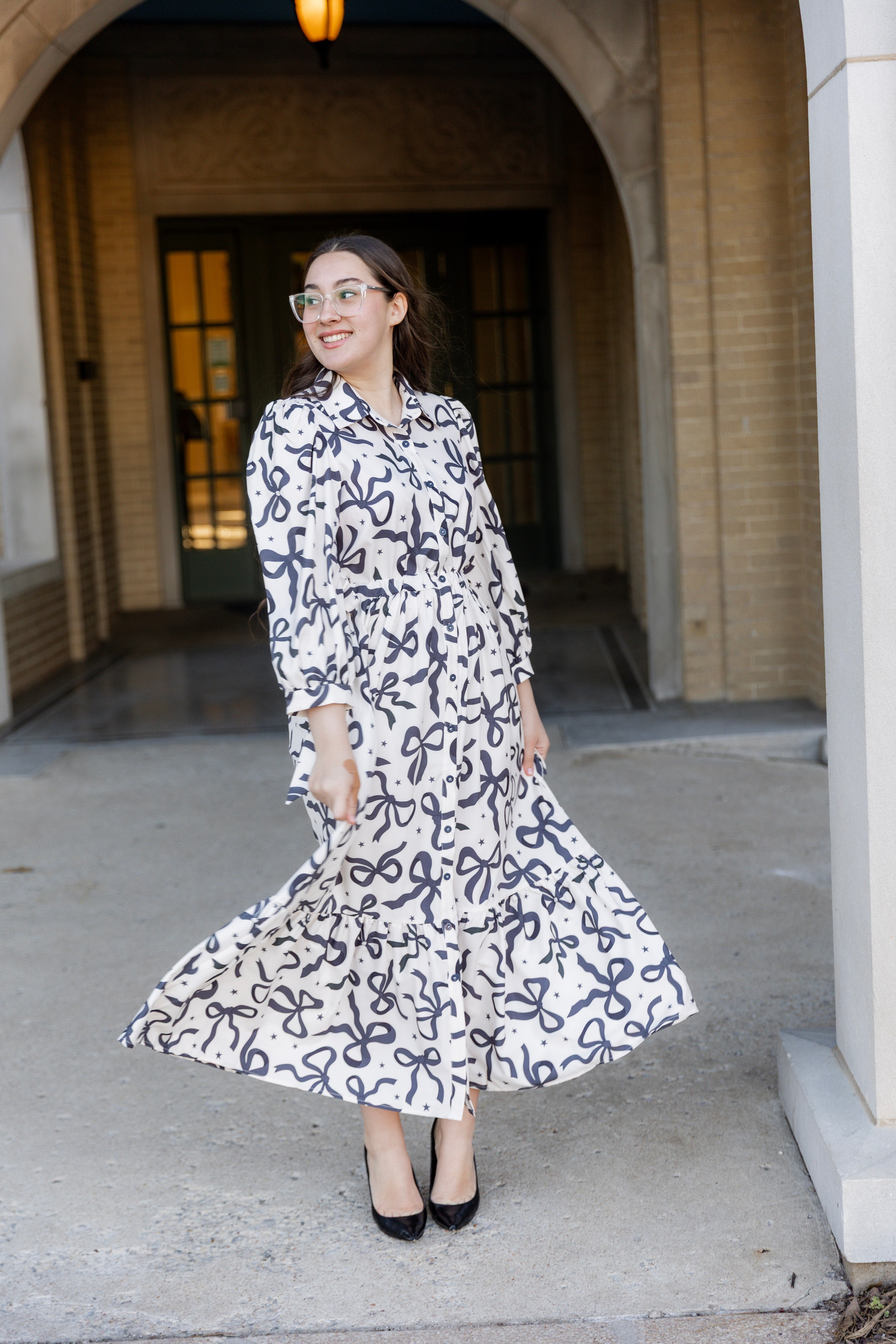 Model wearing the Nuggles® Leila Dress in Bow & Tell