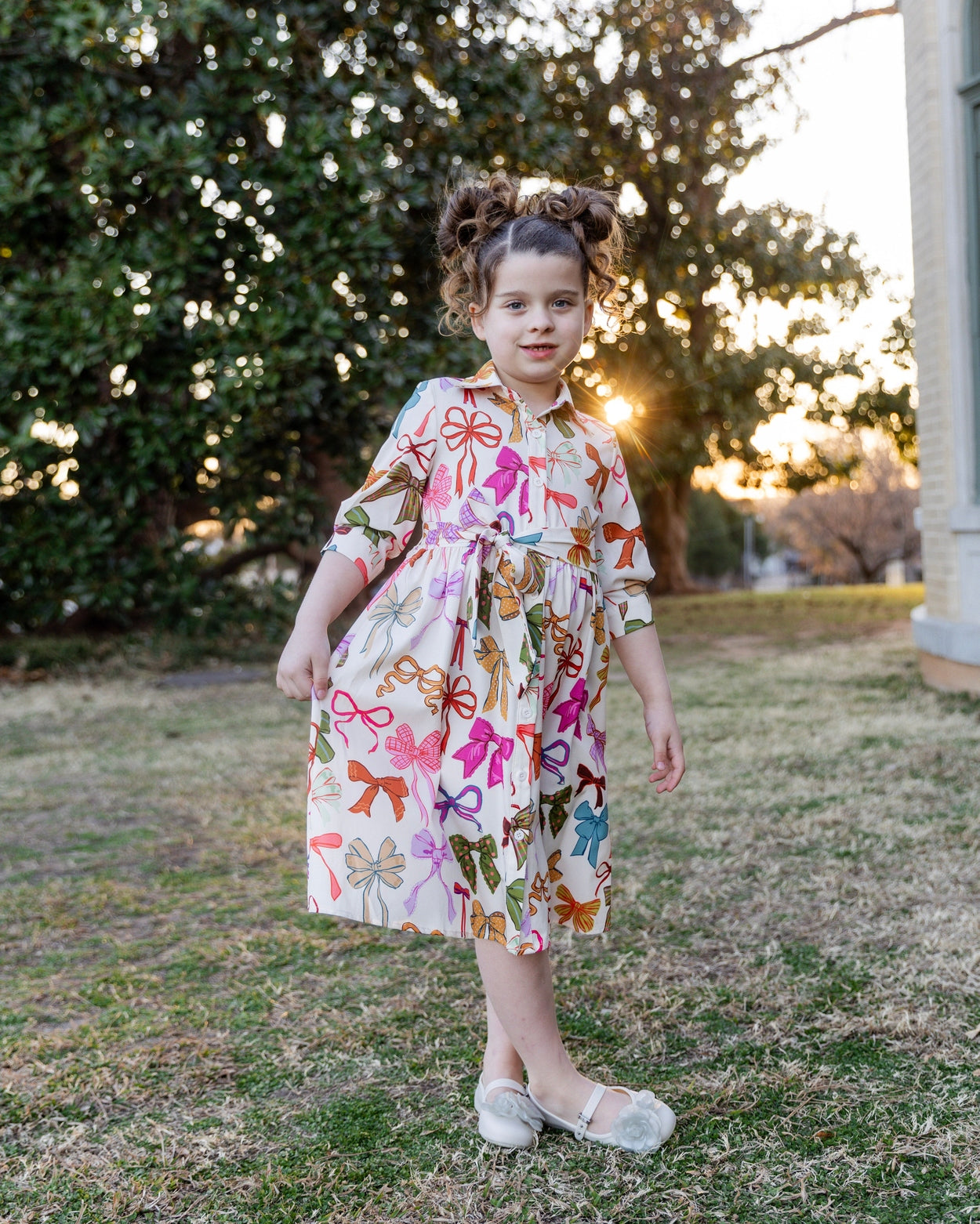 Model wearing the Nuggles® Girls' Rachel Dress in Bow Garden