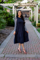 Modest sleeveless midi dress with tiered skirt and fitted bodice, styled for layering with a crew neckline – Hannah Layering Dress by Nuggles®.