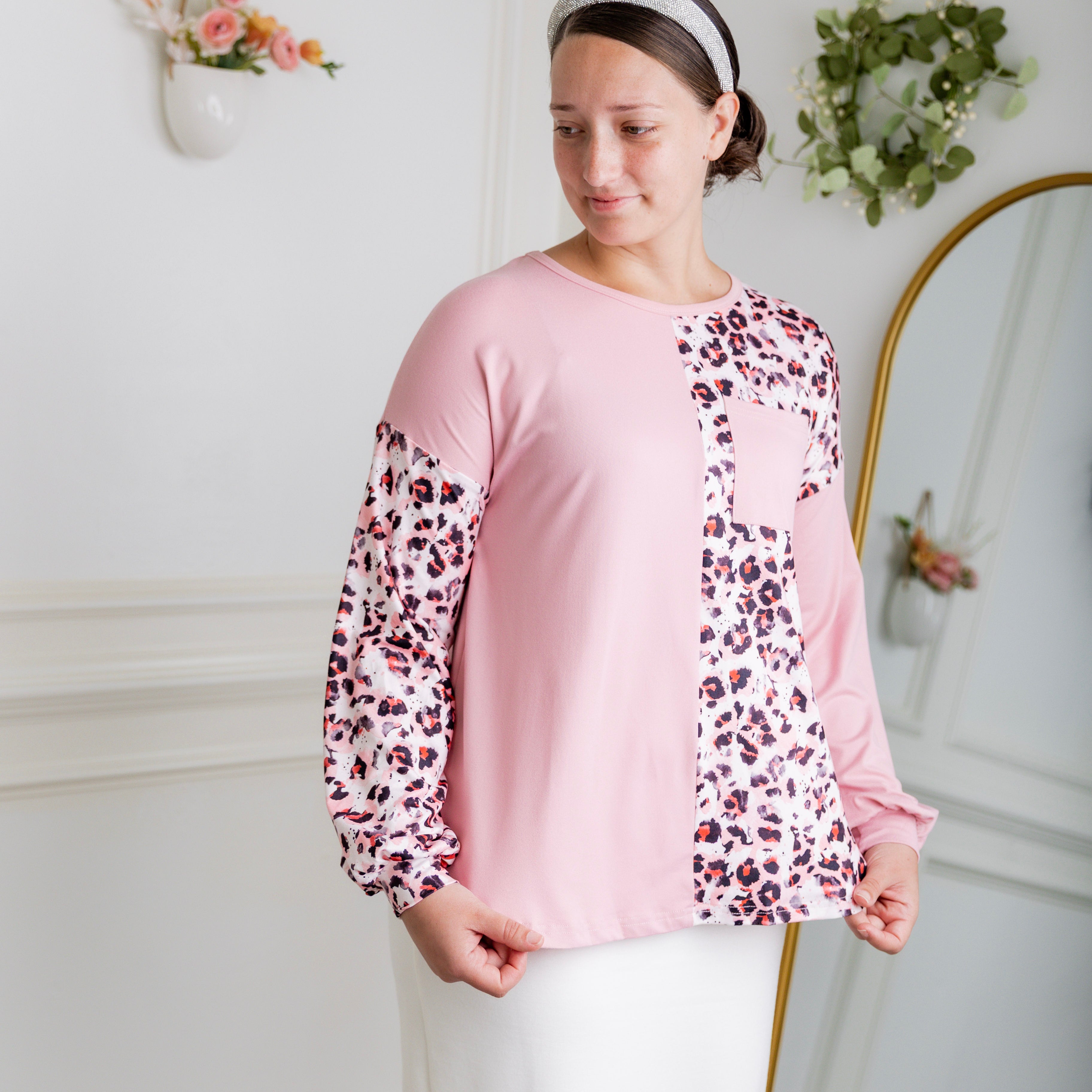 Model wearing the Nuggles® Harlow Top with red and navy color block design.