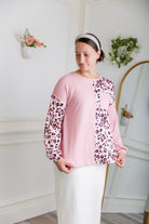 Model wearing the Nuggles® Harlow Top with red and navy color block design.