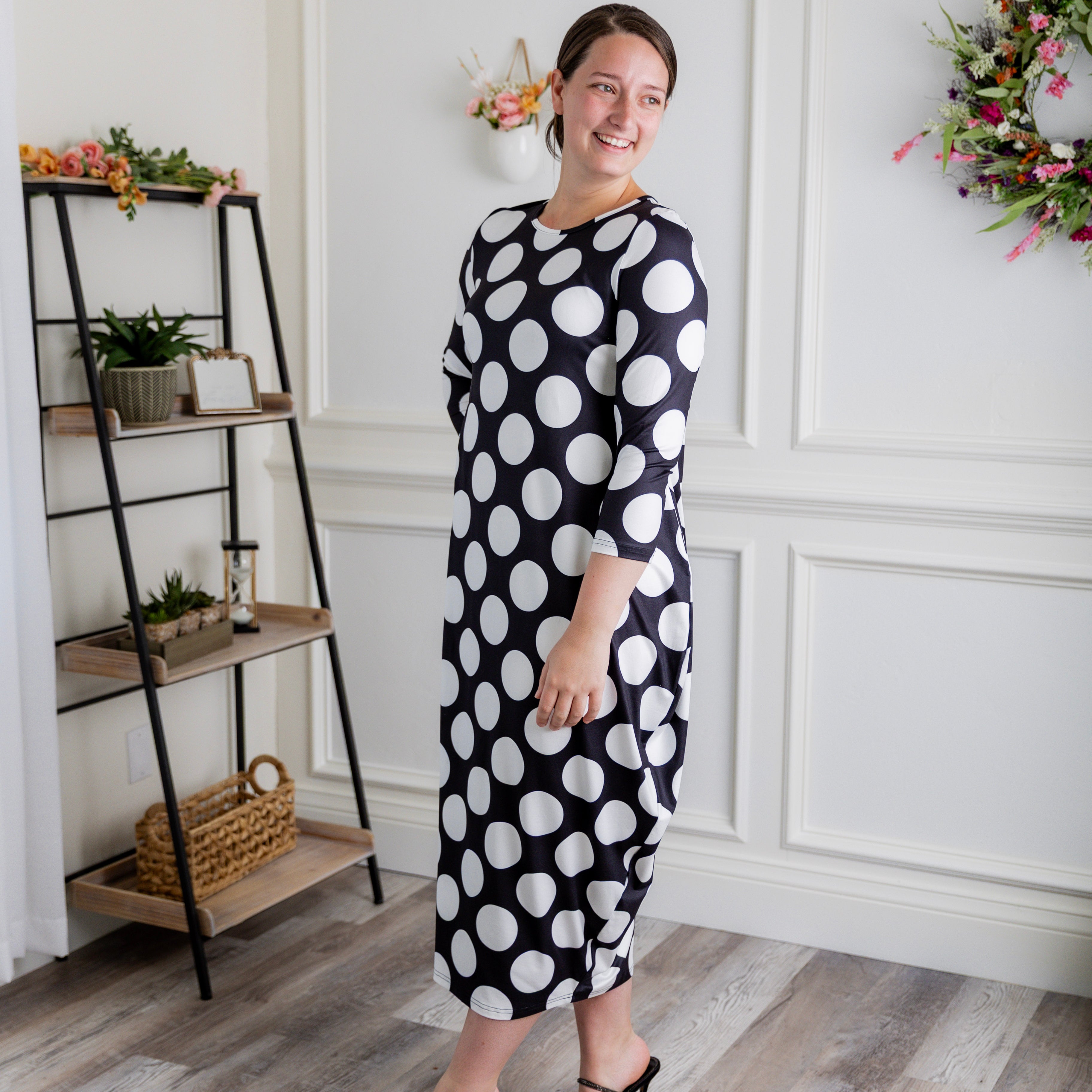 Model wearing Emma Bubble Dress in pretty prints, showcasing full bubble skirt and modest fit.