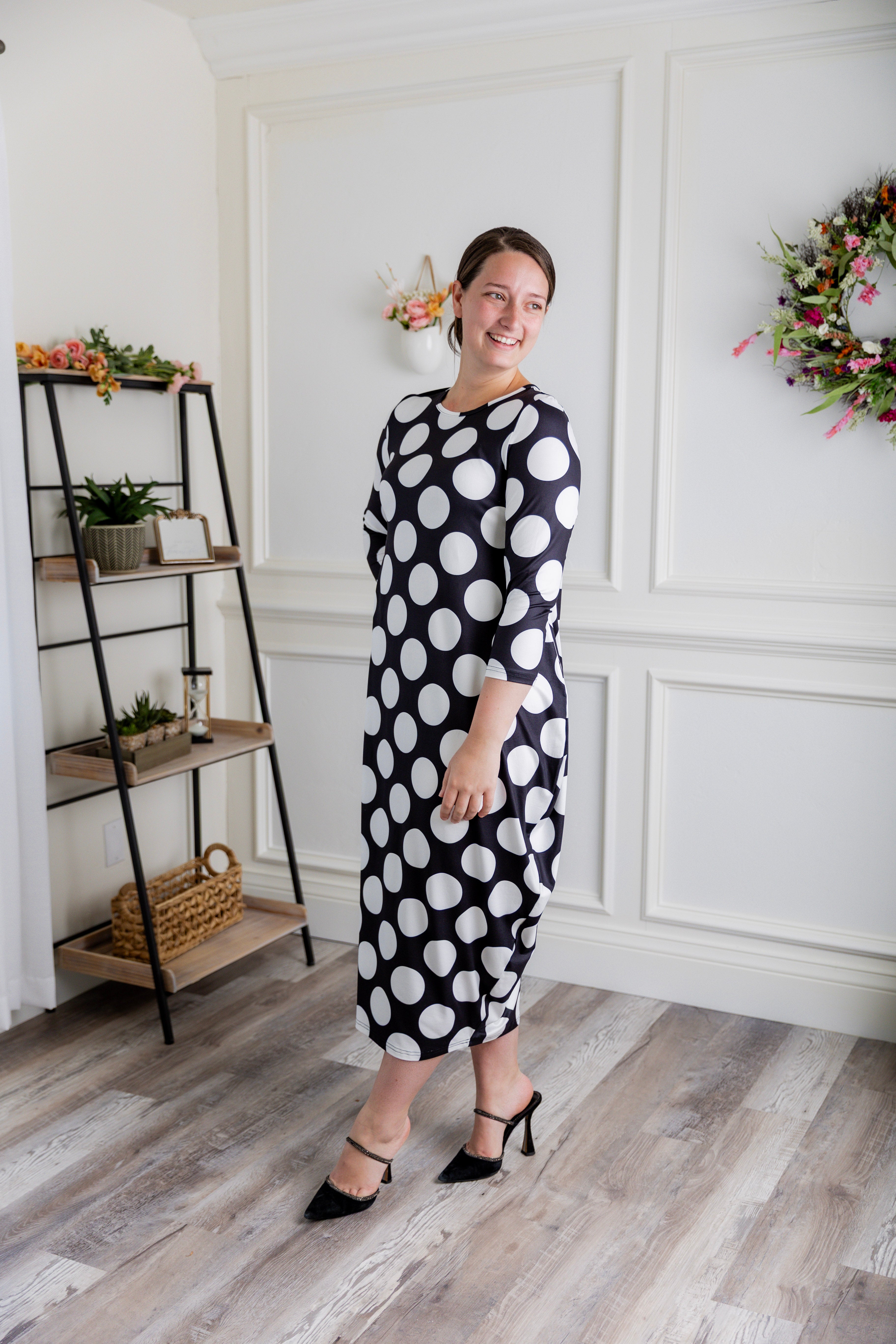 Model wearing Emma Bubble Dress in pretty prints, showcasing full bubble skirt and modest fit.