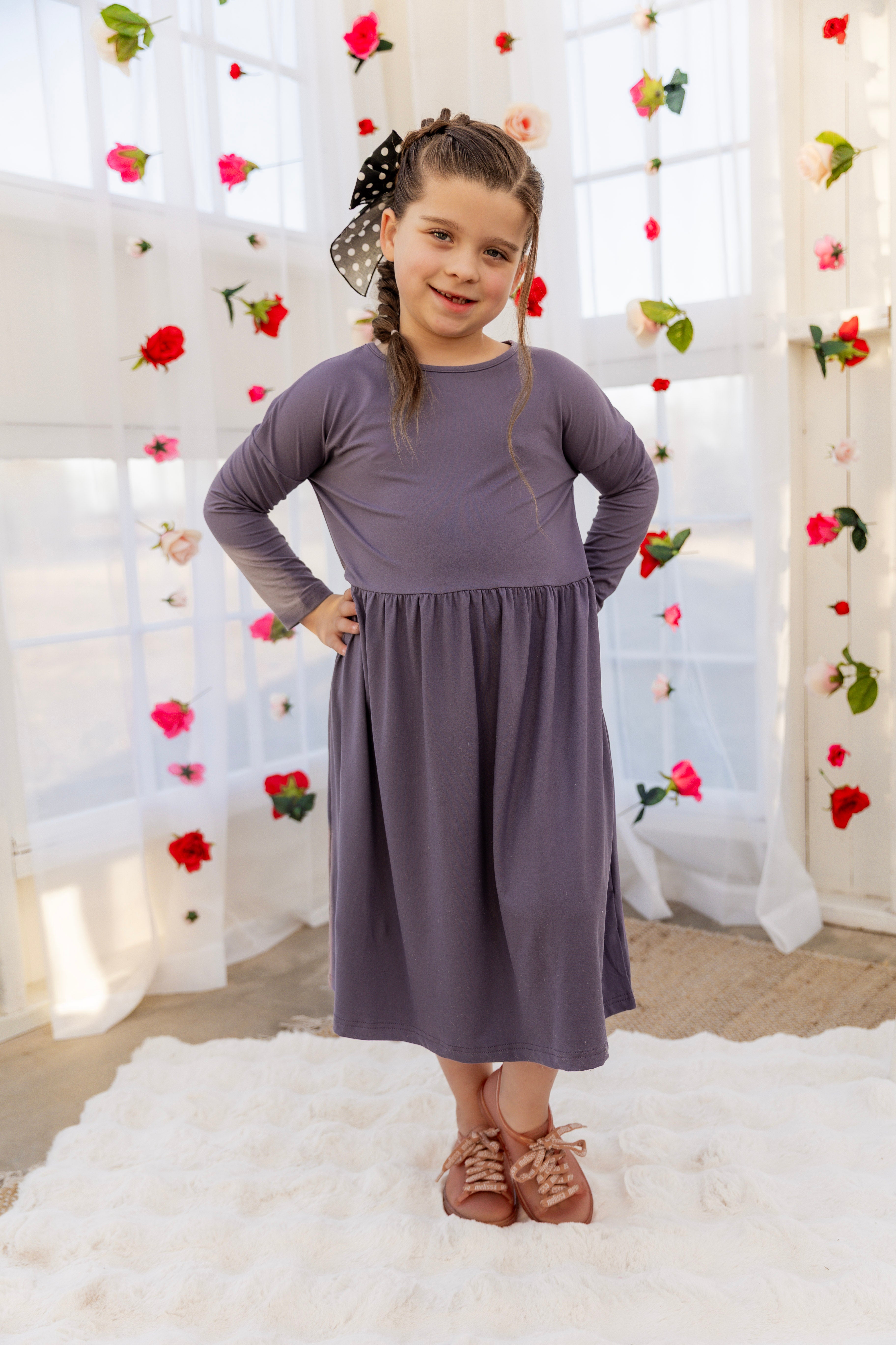 Model wearing the Nuggles® Girls' Farah Dress in Purple