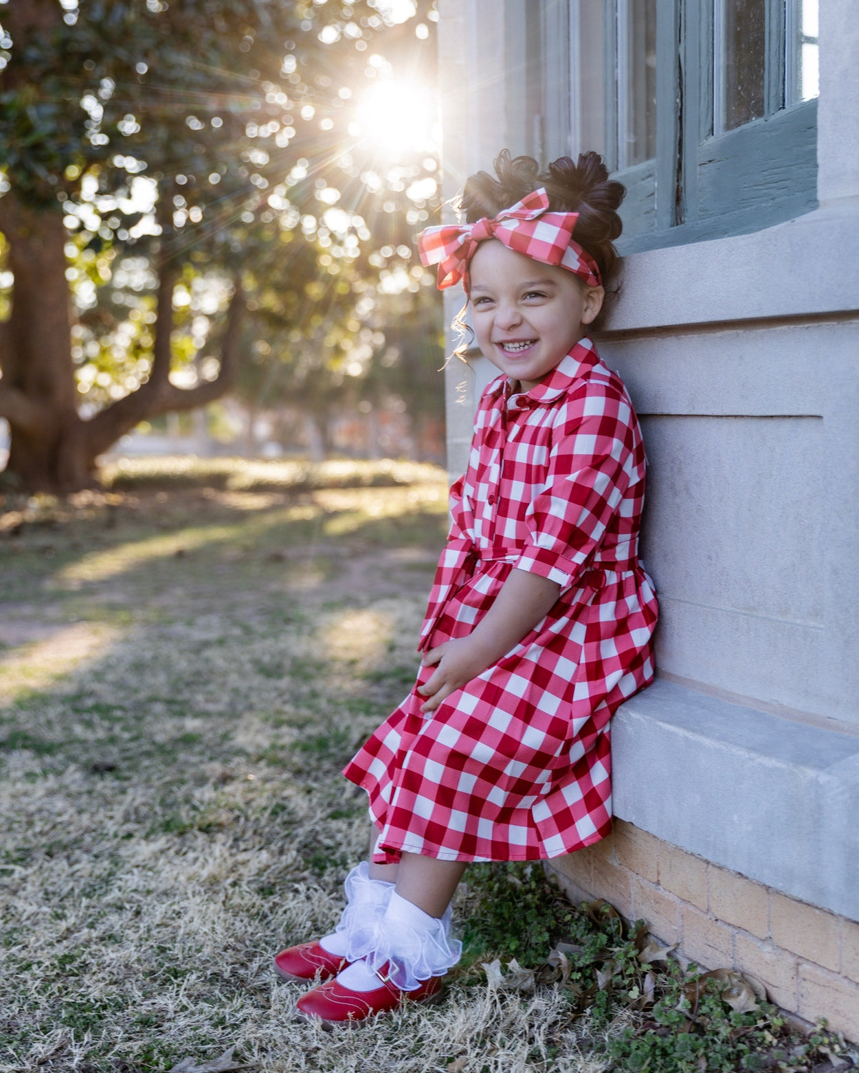 Model wearing the Nuggles® Girls' Rachel Dress in Cherry Jam
