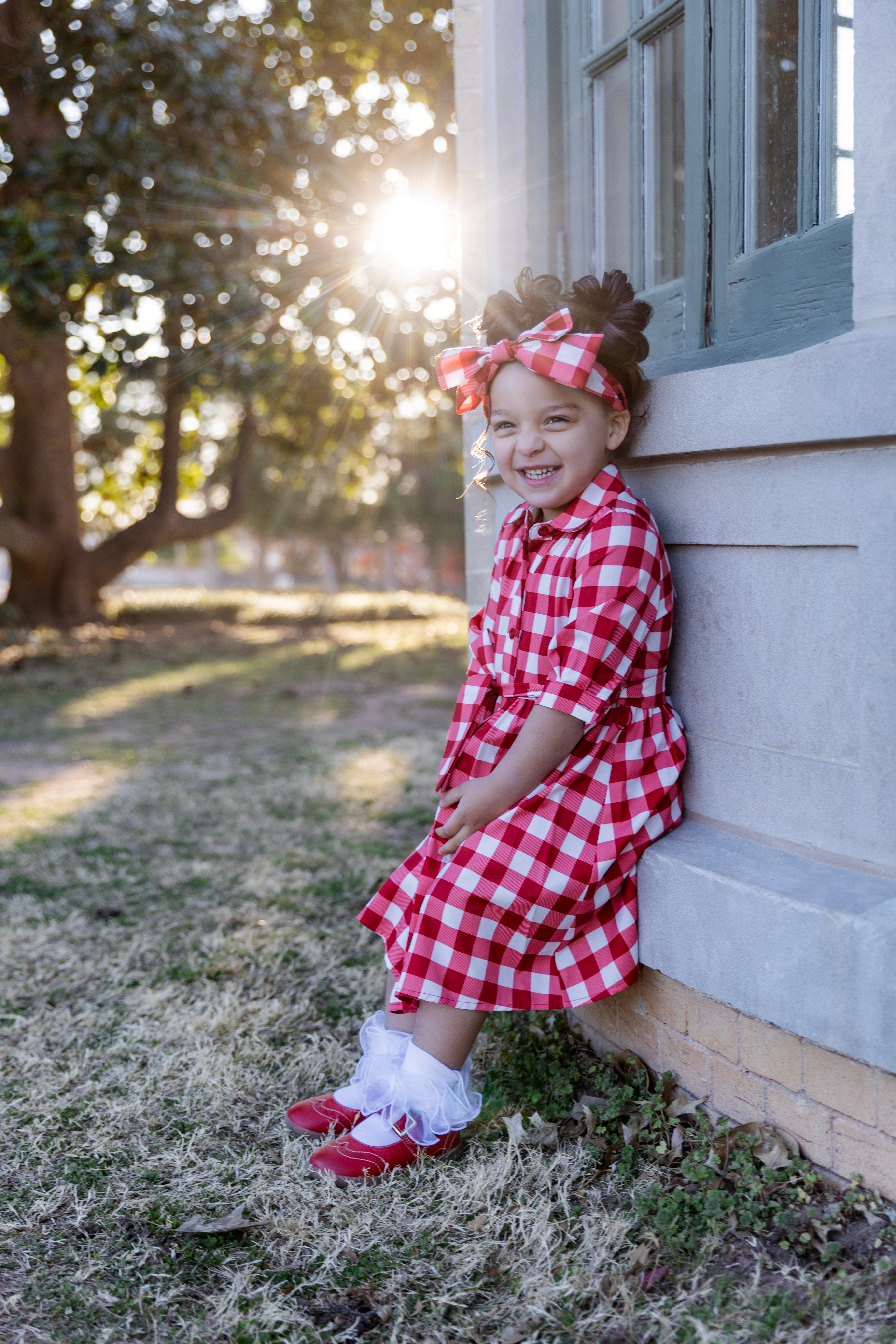 Model wearing the Nuggles® Girls' Rachel Dress in Cherry Jam