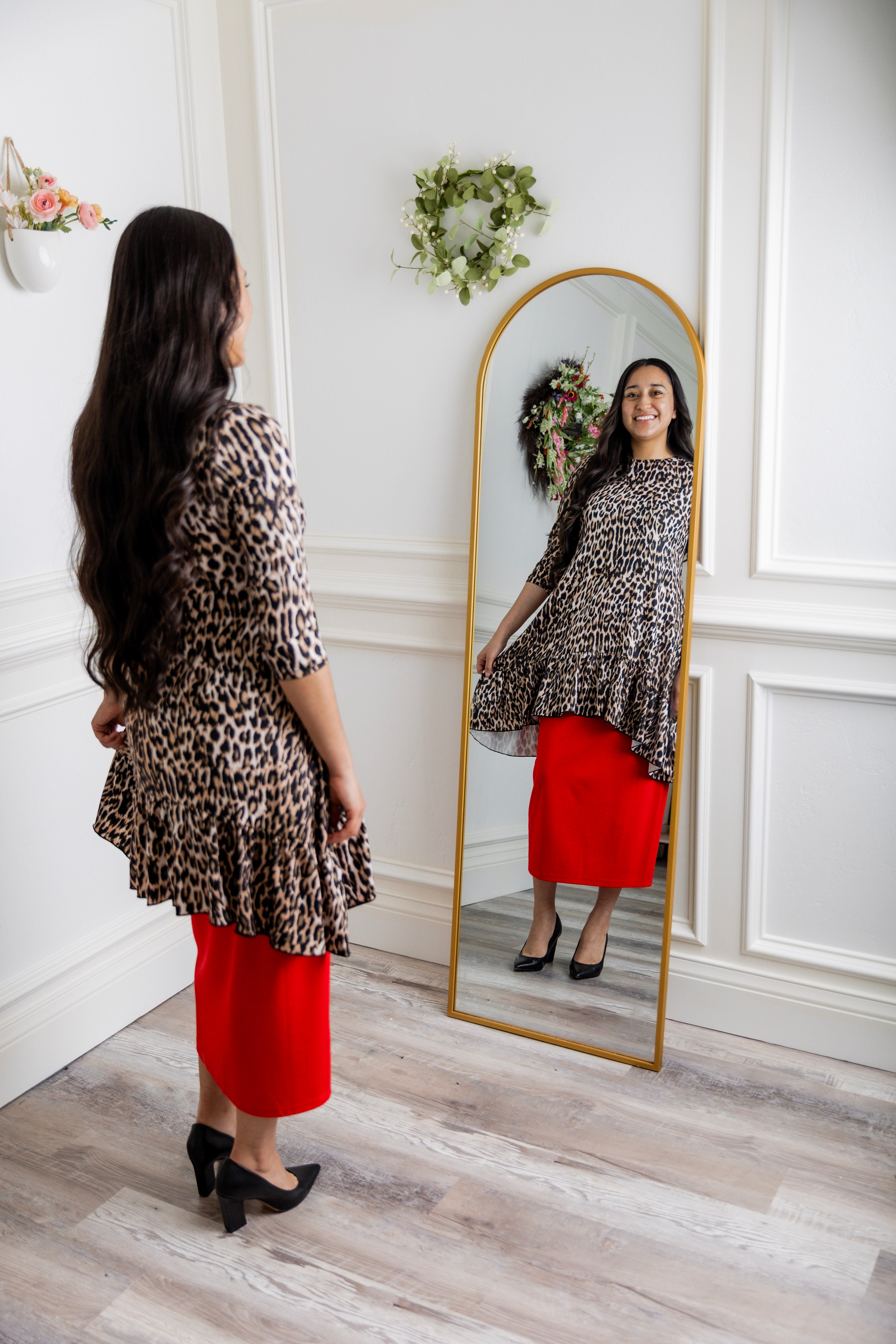 Leopard print modest tunic top for women – Nuggles® Rose Top with swing fit and ruffle hem, paired with red skirt.