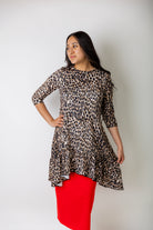 Leopard print modest tunic top for women – Nuggles® Rose Top with swing fit and ruffle hem, paired with red skirt.