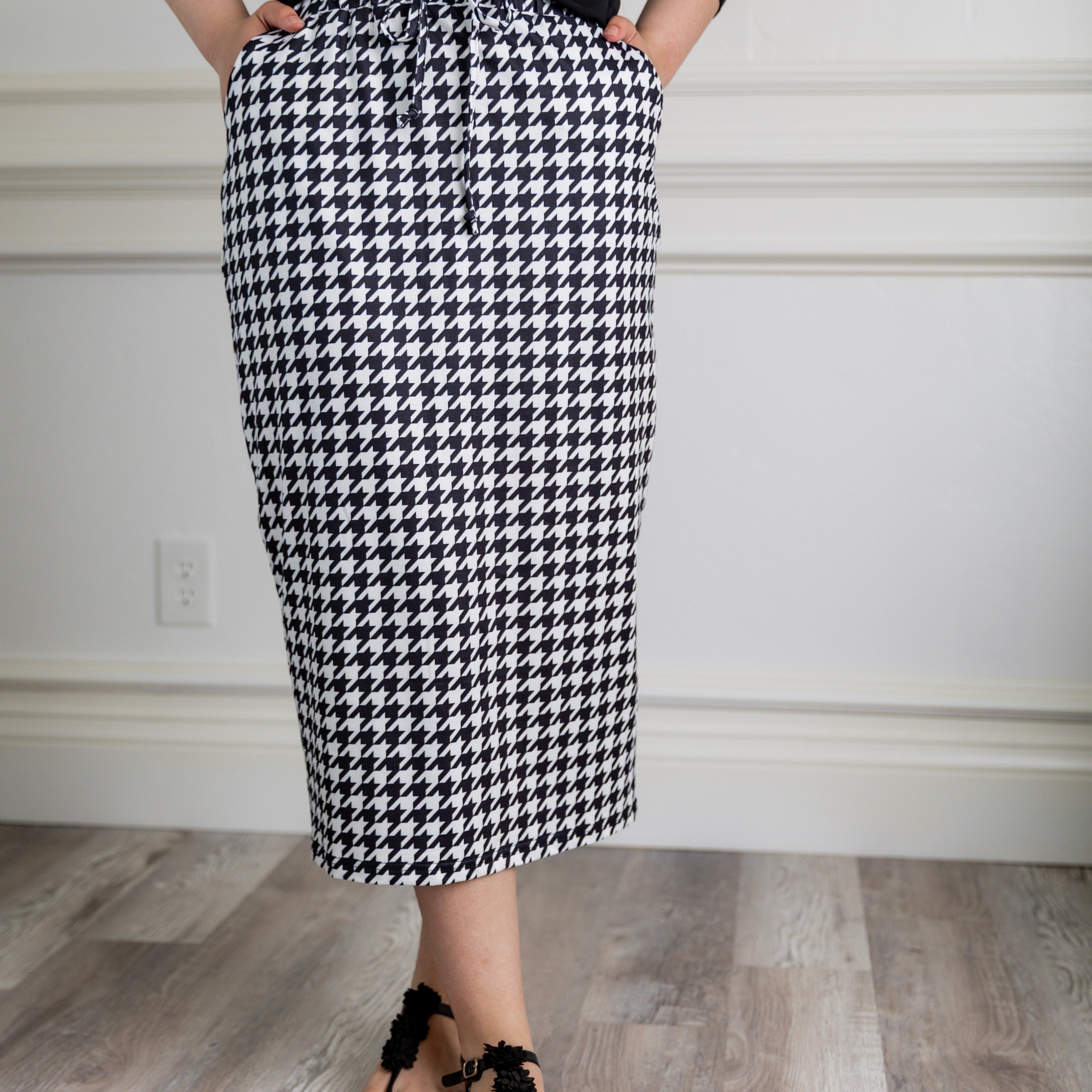 Model wearing Nuggles® 31-inch Drawstring T-Skirt in prints. Modest midi skirt with side pockets, soft stretch waistband, and adjustable drawstring. Lightweight knit fabric, perfect for everyday comfort and style.