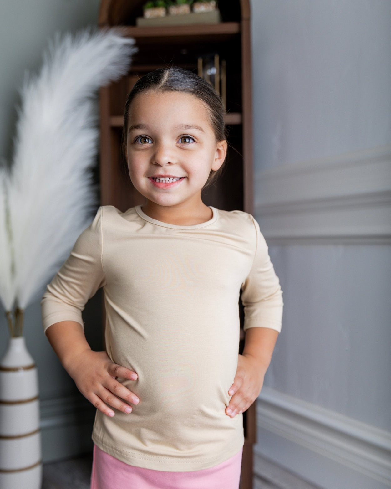 Model wearing our Nuggles® Girls Essential 3/4 sleeve tee.