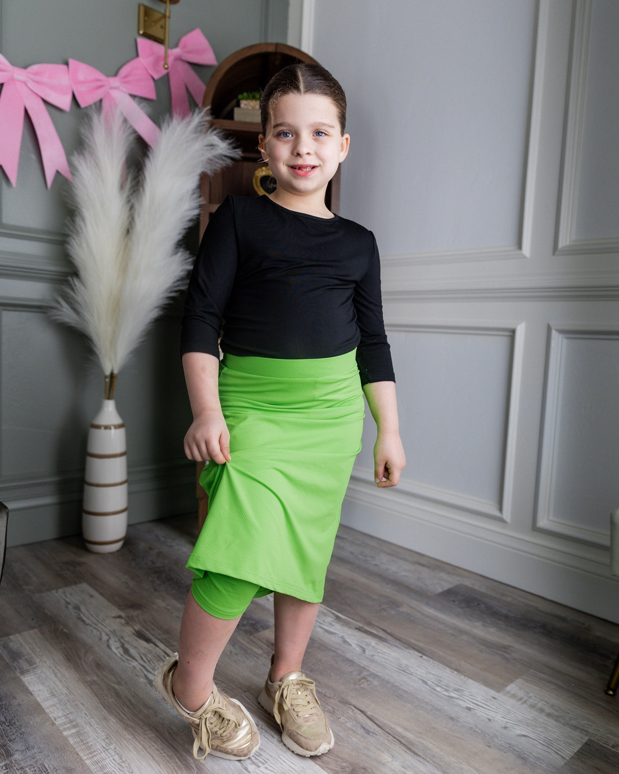 Model wearing Nuggles® Girls' All-Sport Skirt in Green