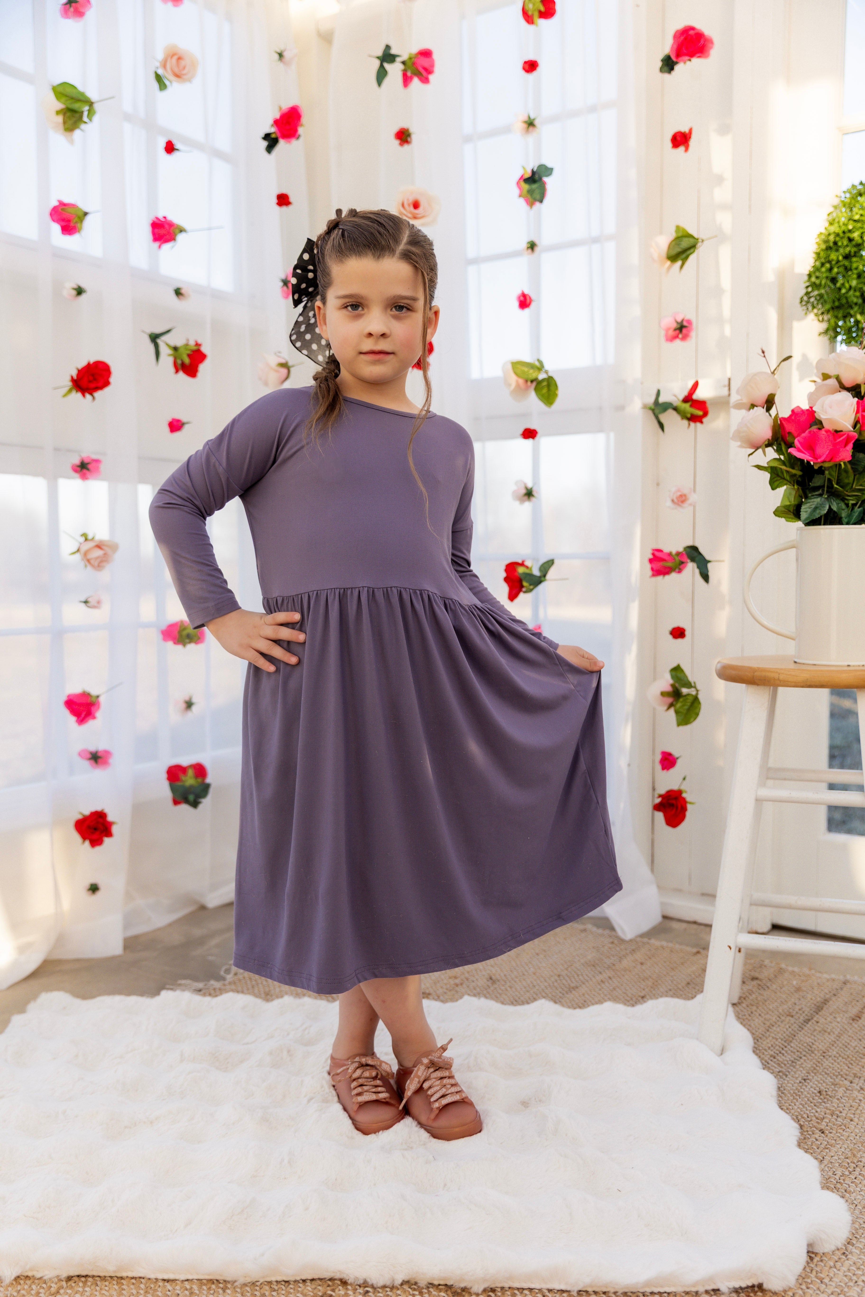 Model wearing the Nuggles® Girls' Farah Dress in Purple