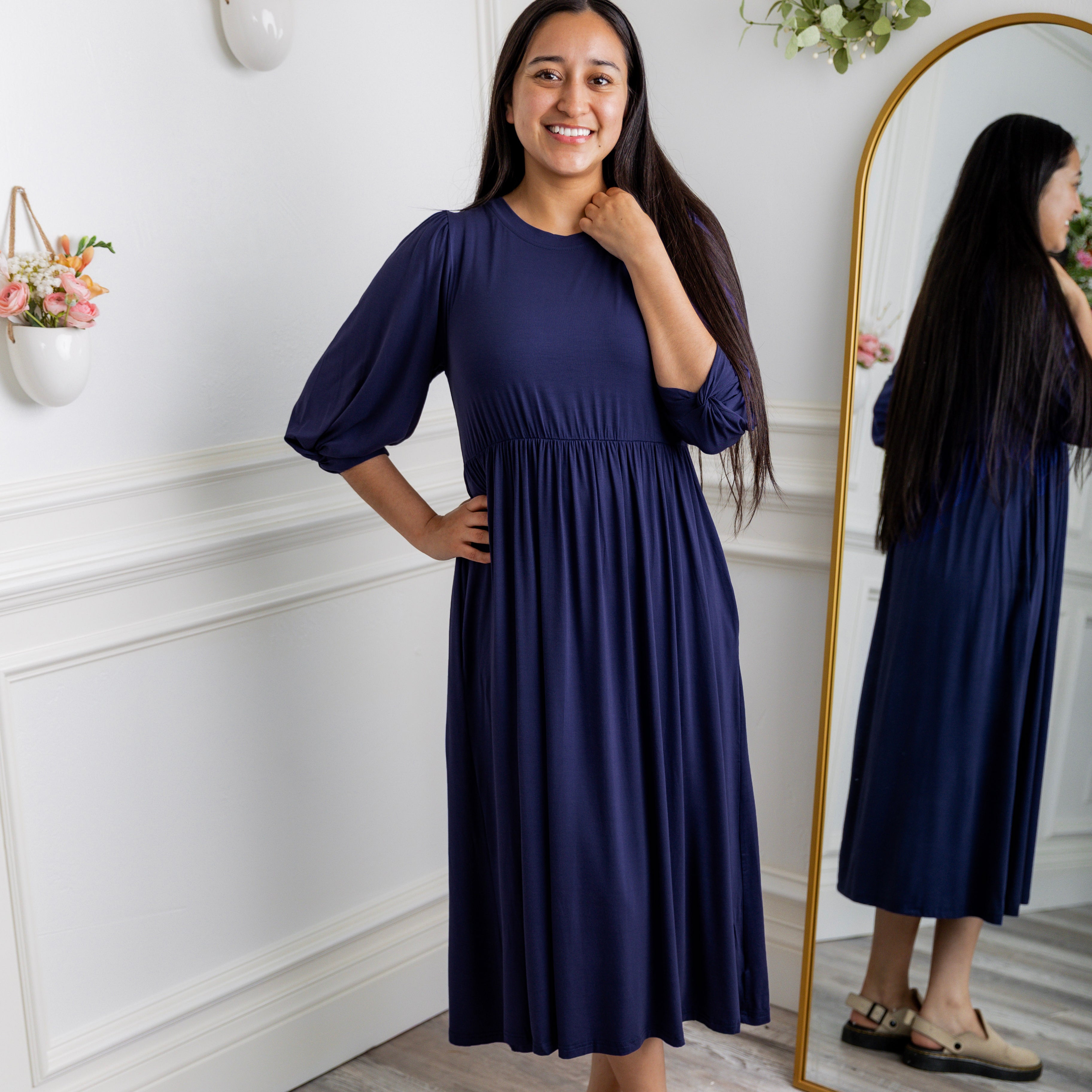 Modest Willow Solid Colors Dress by Nuggles® featuring a gathered waist, balloon sleeves, and side pockets; shown in various solid colors and angles for a stylish, comfortable everyday look.