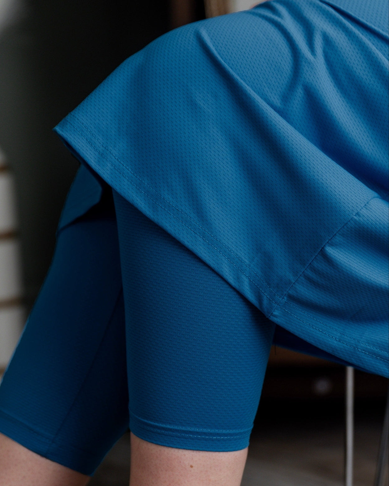 Model wearing Nuggles® 31" All-Sport Skirt in Turquoise