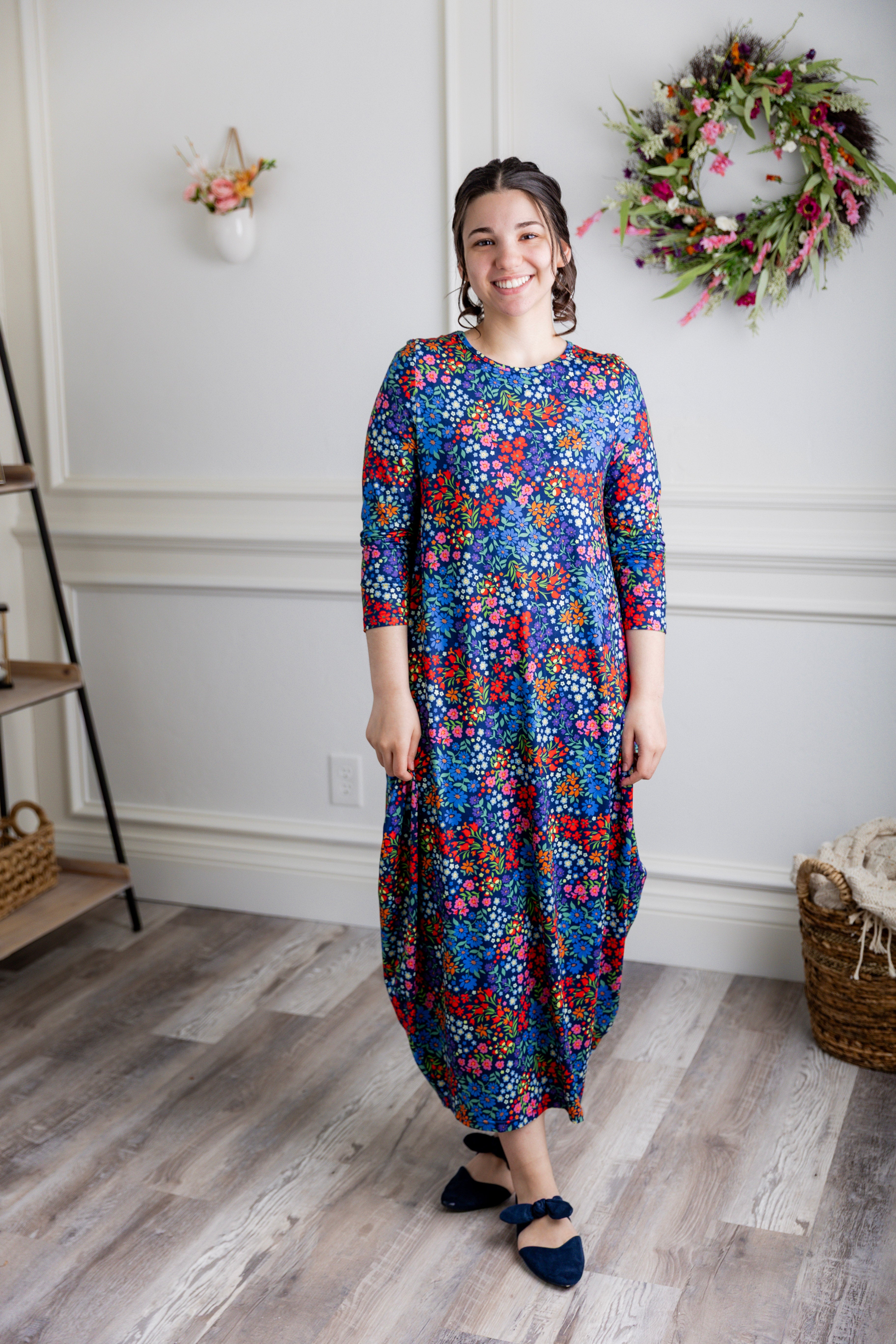 Model wearing Emma Bubble Dress in pretty prints, showcasing full bubble skirt and modest fit.