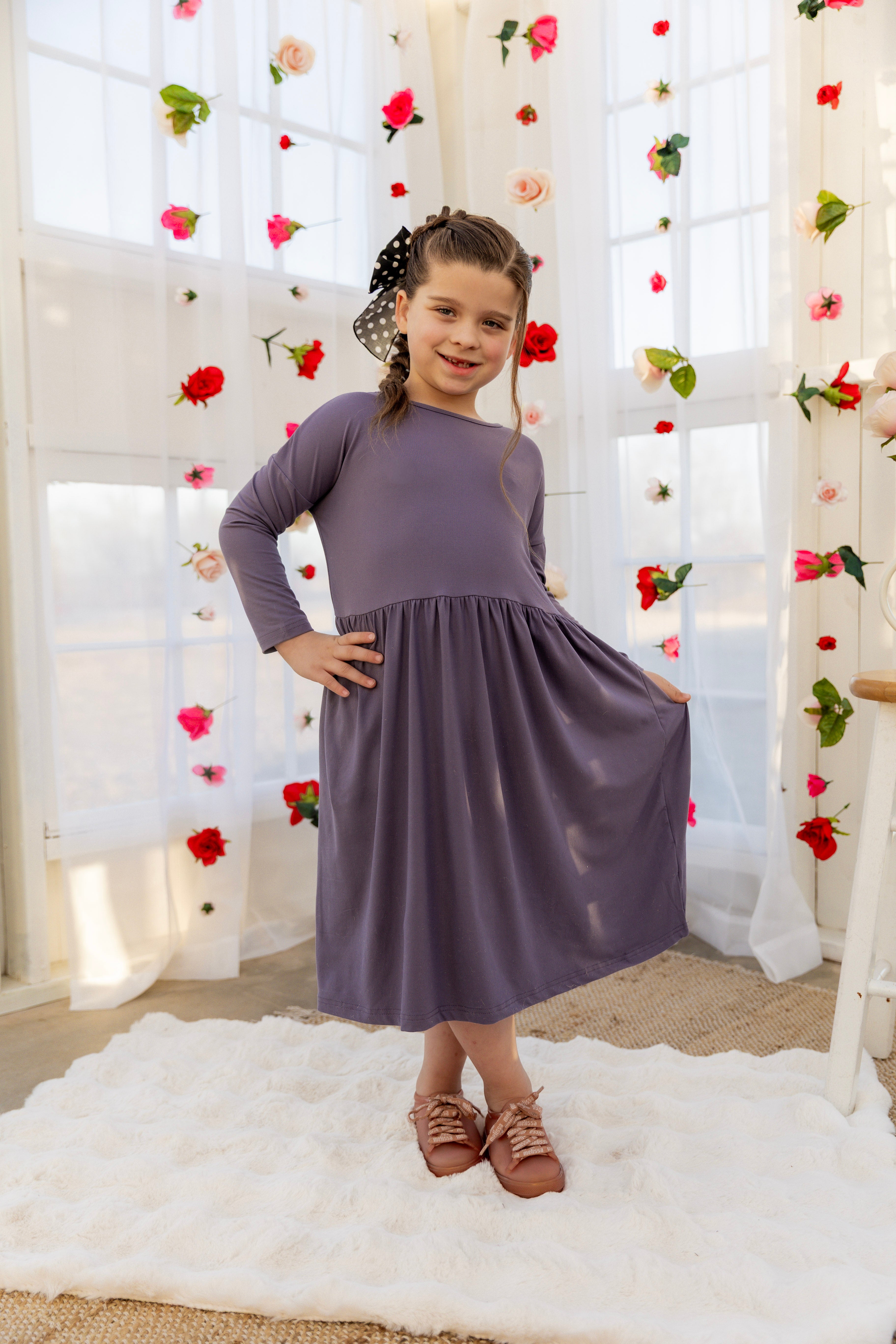 Model wearing the Nuggles® Girls' Farah Dress in Purple