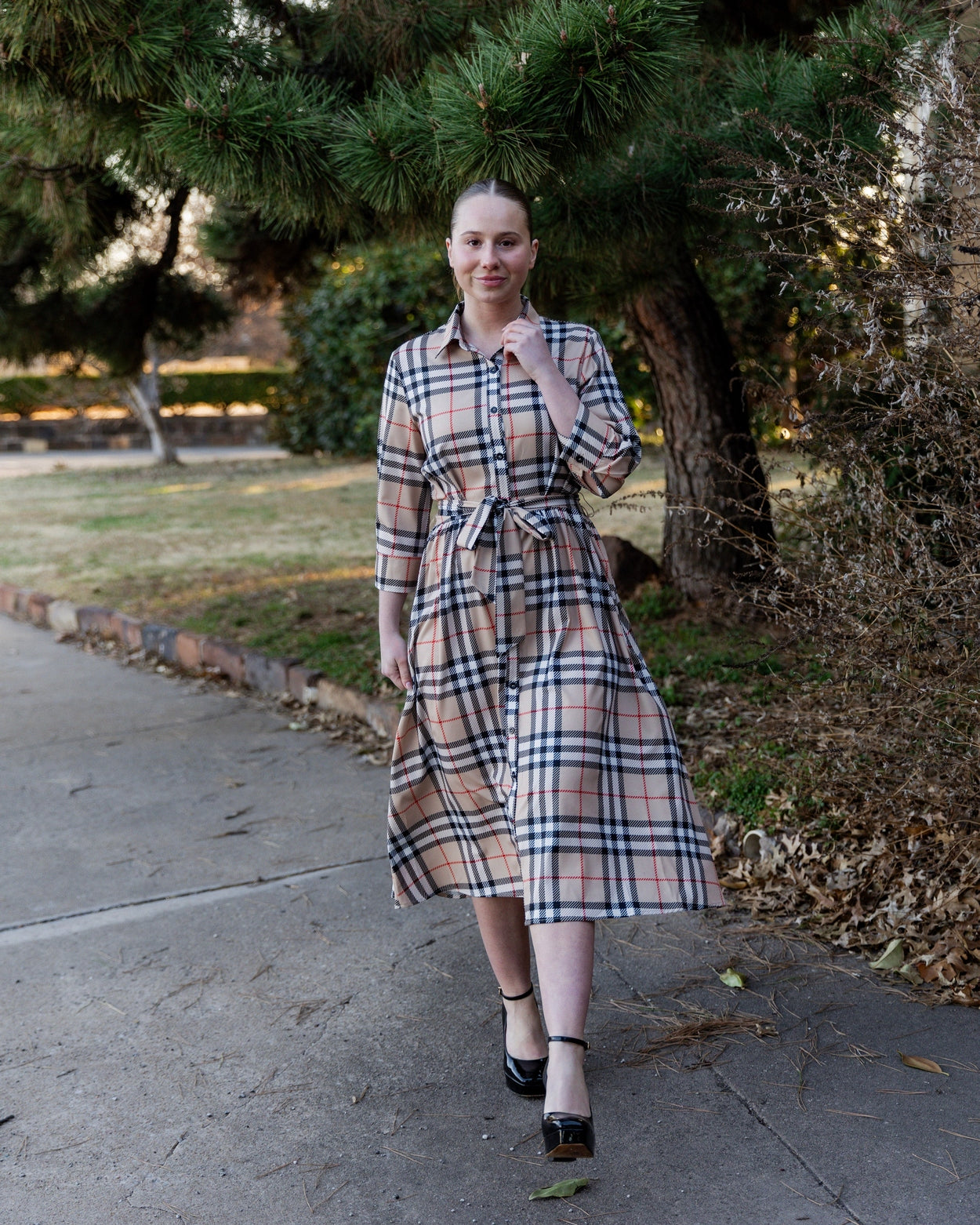 Model wearing the Nuggles® Rachel Dress in Sand Plaid