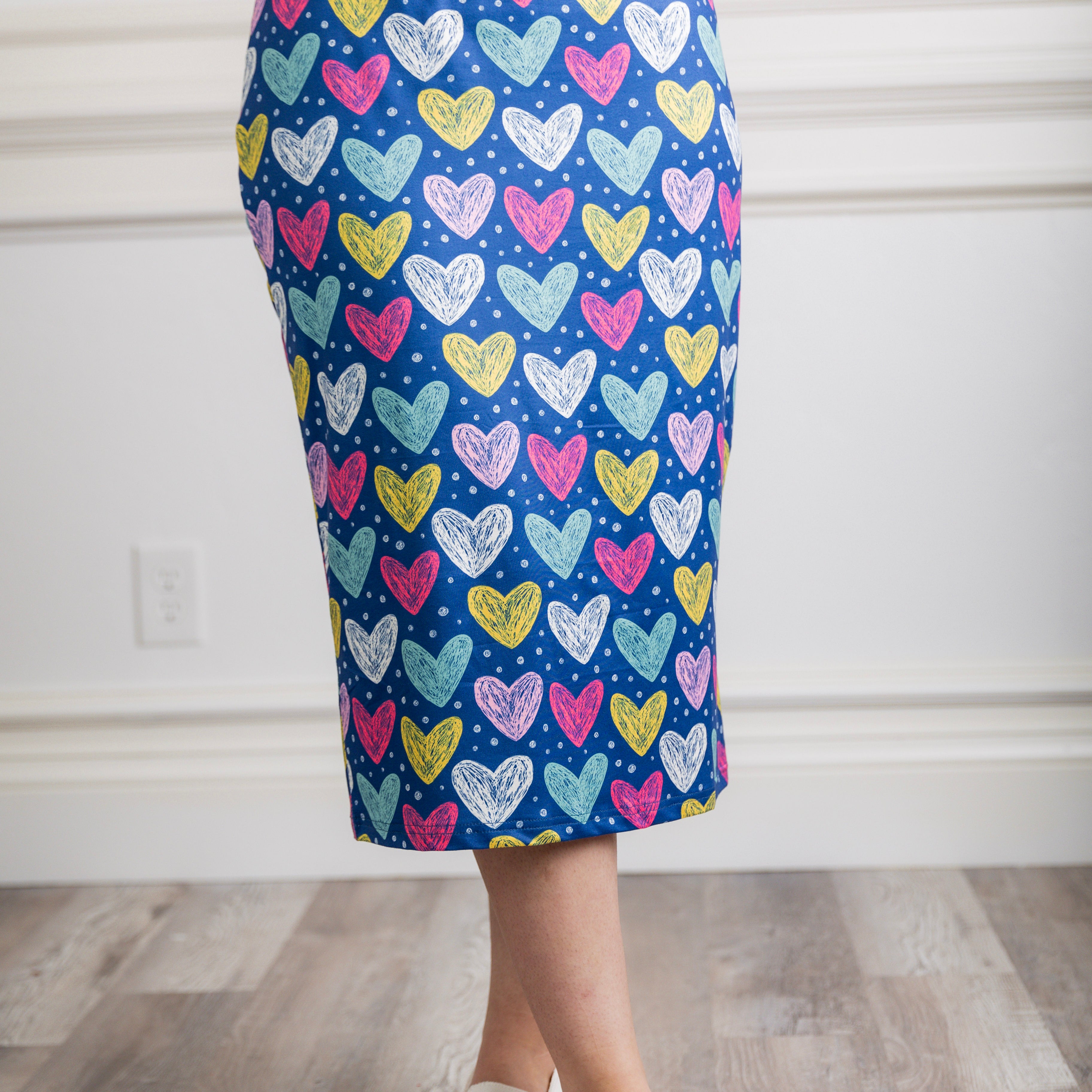 Model showcasing  Nuggles® midi tee skirts in various solid colors, modest 27" and 31" lengths