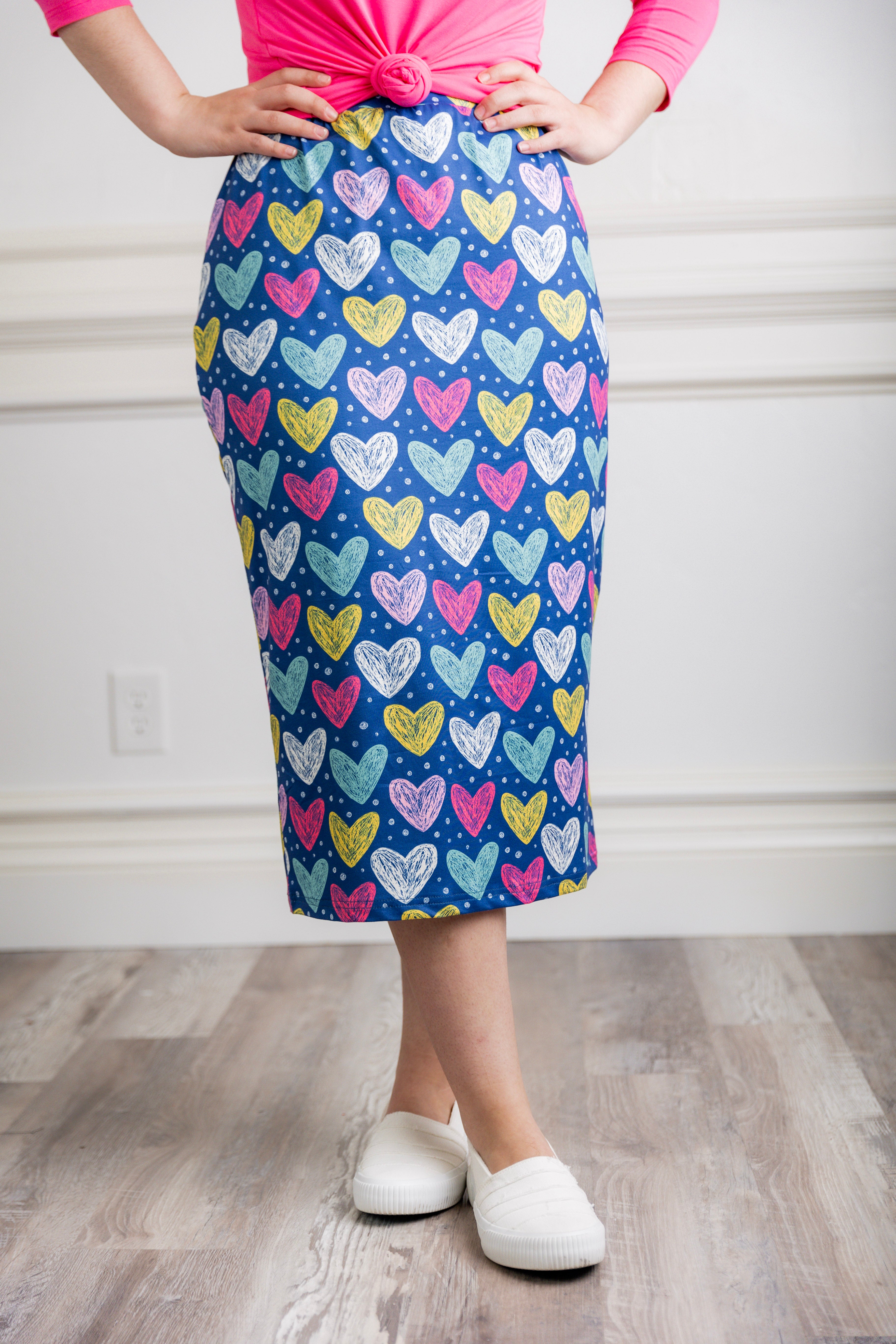 Model showcasing  Nuggles® midi tee skirts in various solid colors, modest 27" and 31" lengths