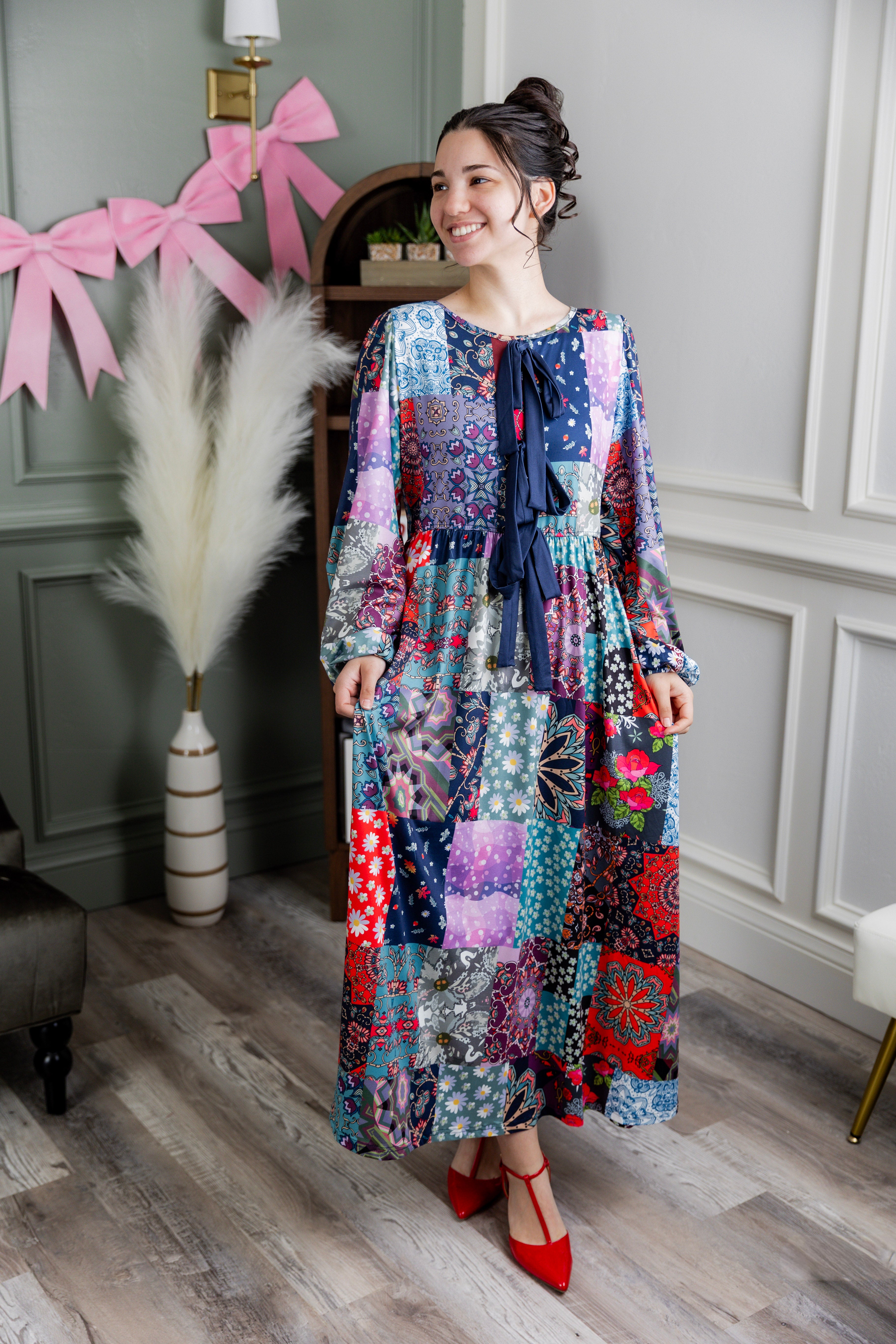 Model wearing the Nuggles® Addison Dress in Stitch & Sparkle