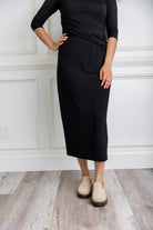 Model wearing a 31-inch classic lightweight midi skirt with an elastic waistband, styled modestly for everyday or church wear.