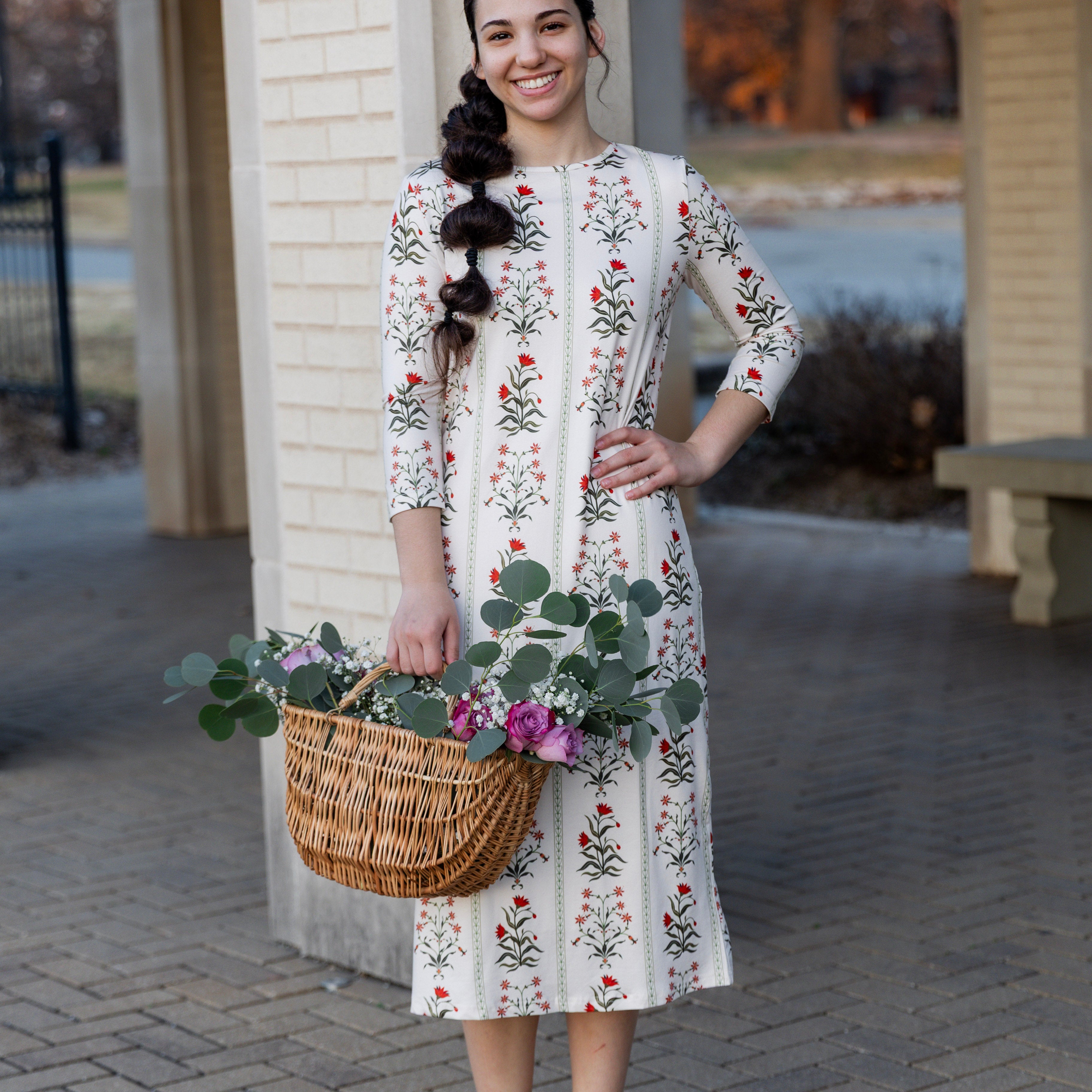 Model wearing Nuggles® original midi layering dress in print