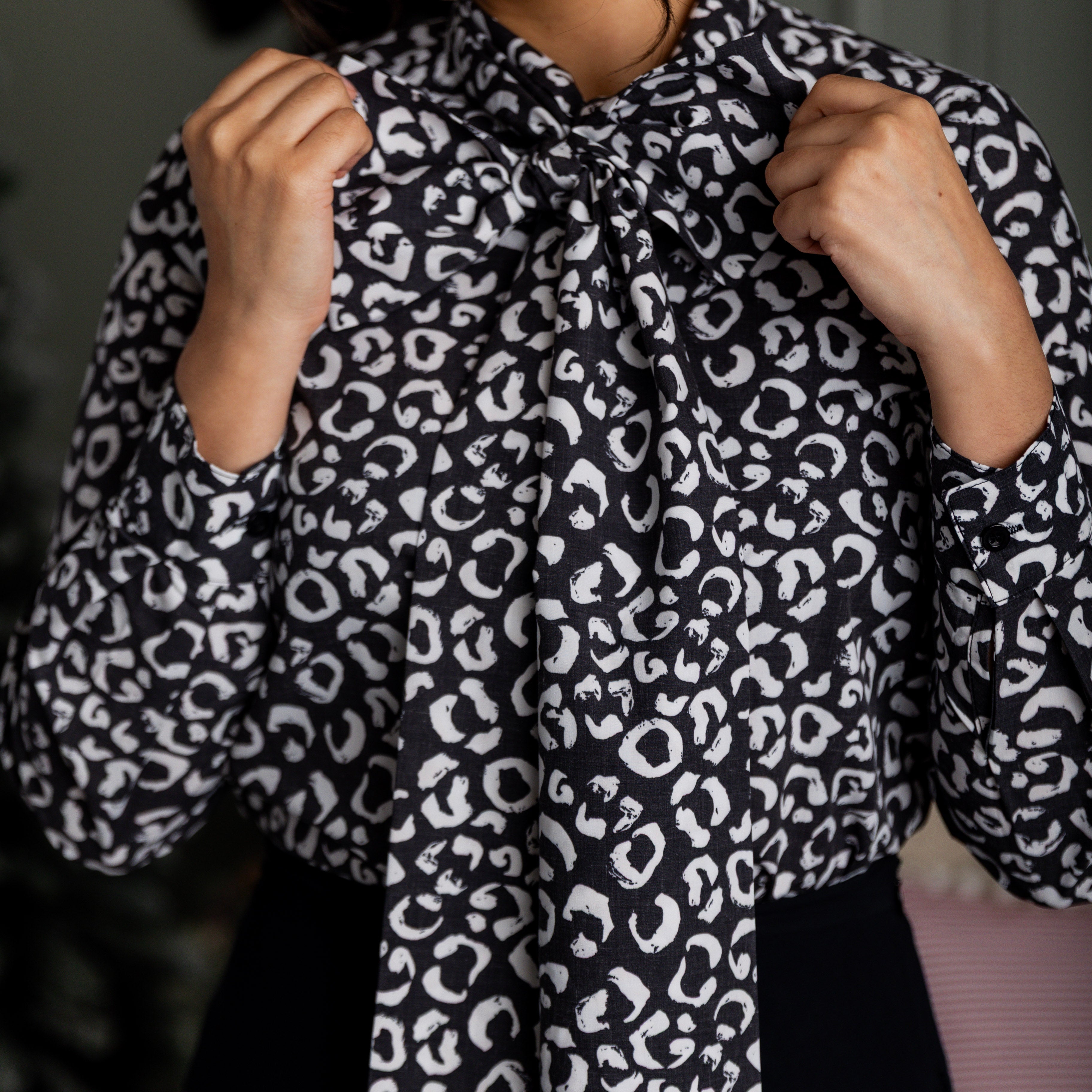 Model wearing Nuggles® Felicity top with large bow tie neckline, modest women's blouse.