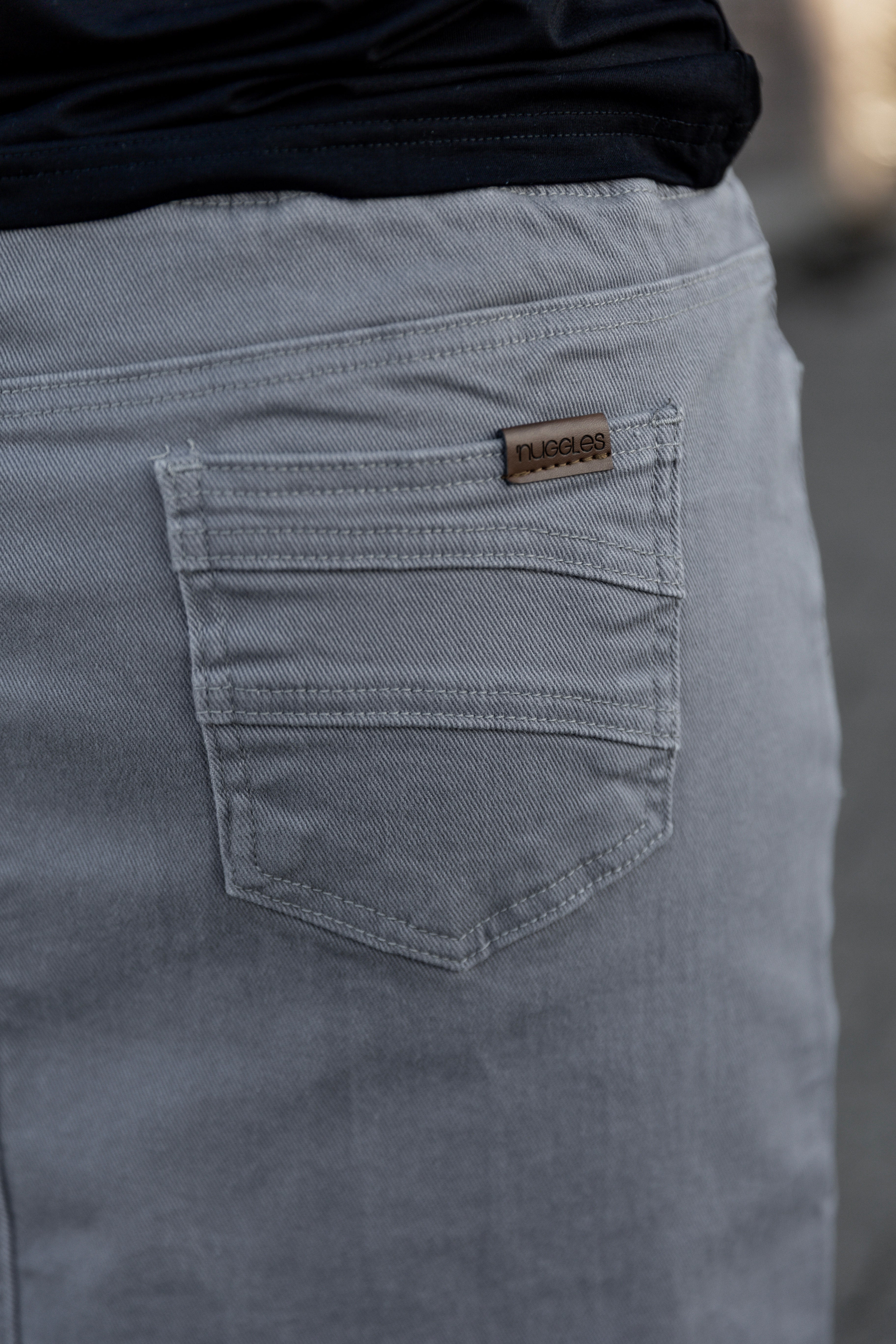 Nuggles® denim midi skirt with soft stretch fabric, wide elastic waistband, modest length, and functional pockets. Available in 27", 31", and 34" lengths.