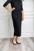 Model wearing a 31-inch classic lightweight midi skirt with an elastic waistband, styled modestly for everyday or church wear.