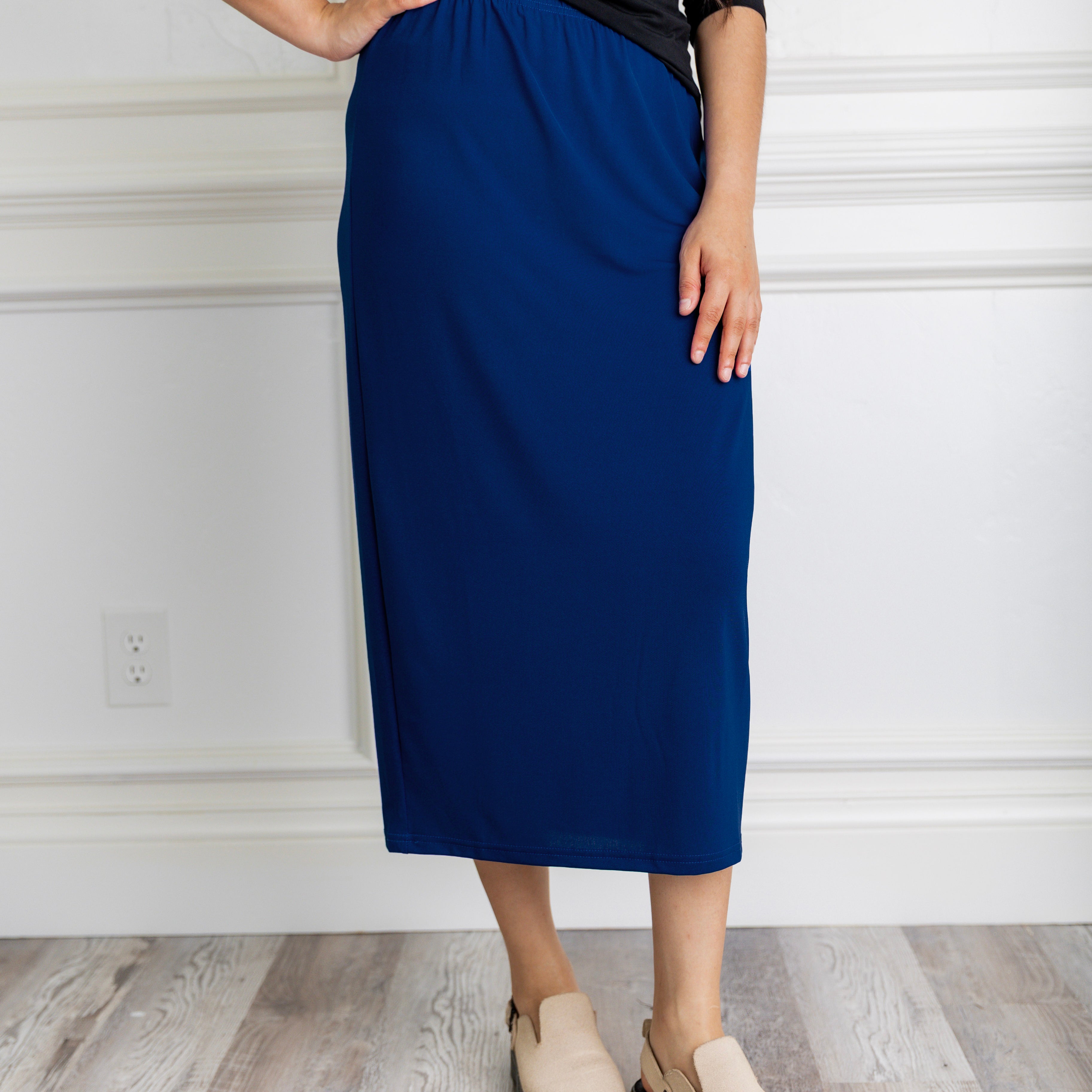 Model wearing a 31-inch classic lightweight midi skirt with an elastic waistband, styled modestly for everyday or church wear.