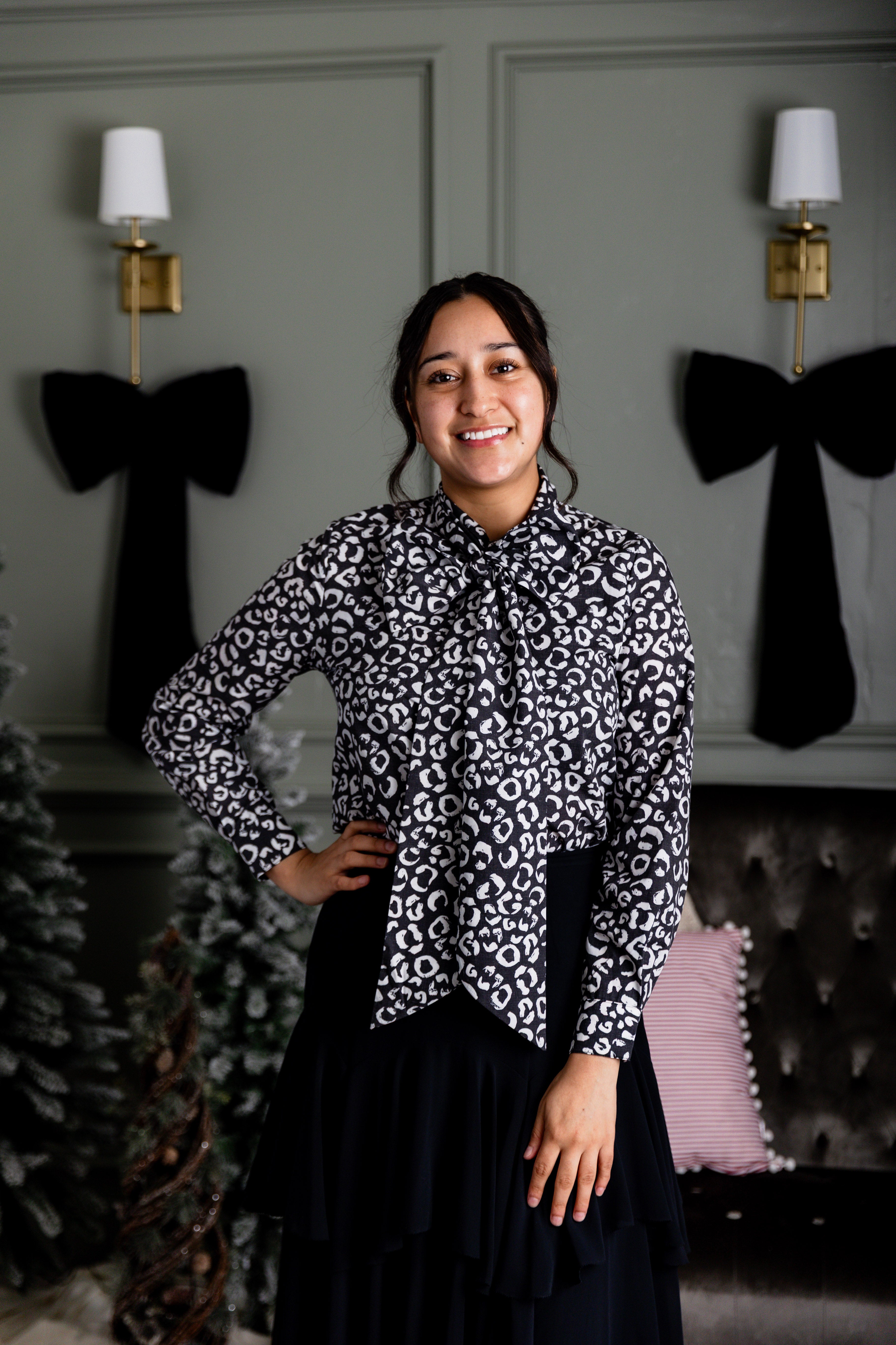 Model wearing Nuggles® Felicity top with large bow tie neckline, modest women's blouse.
