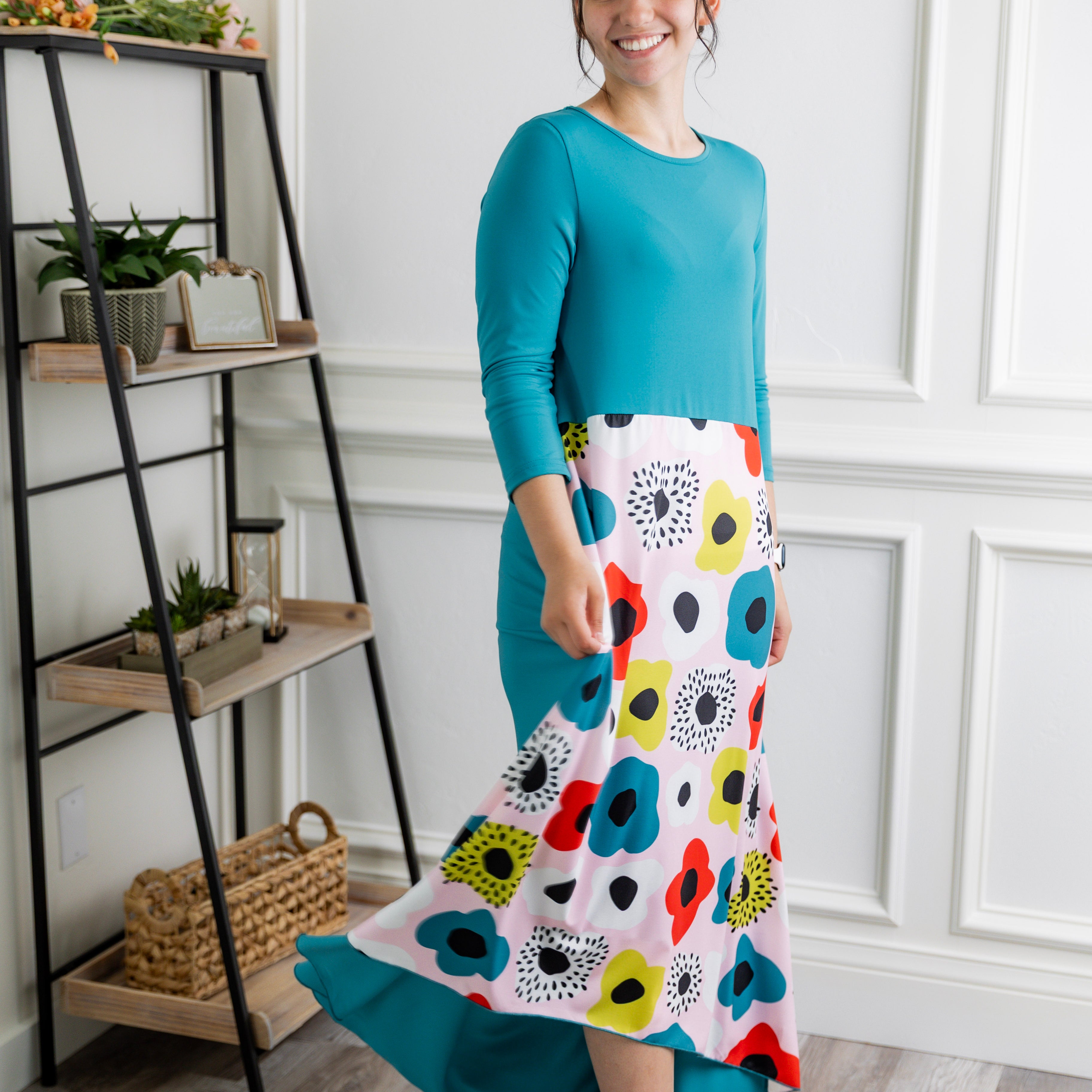 Model modeling Nuggles® Charay Dress with ¾ sleeves and high-low hem. Modest and stylish A-line dress with flattering fit.