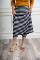 Modest activewear skirt with built-in leggings for women, breathable athletic fabric, paired with sneakers – perfect for workouts or casual wear.