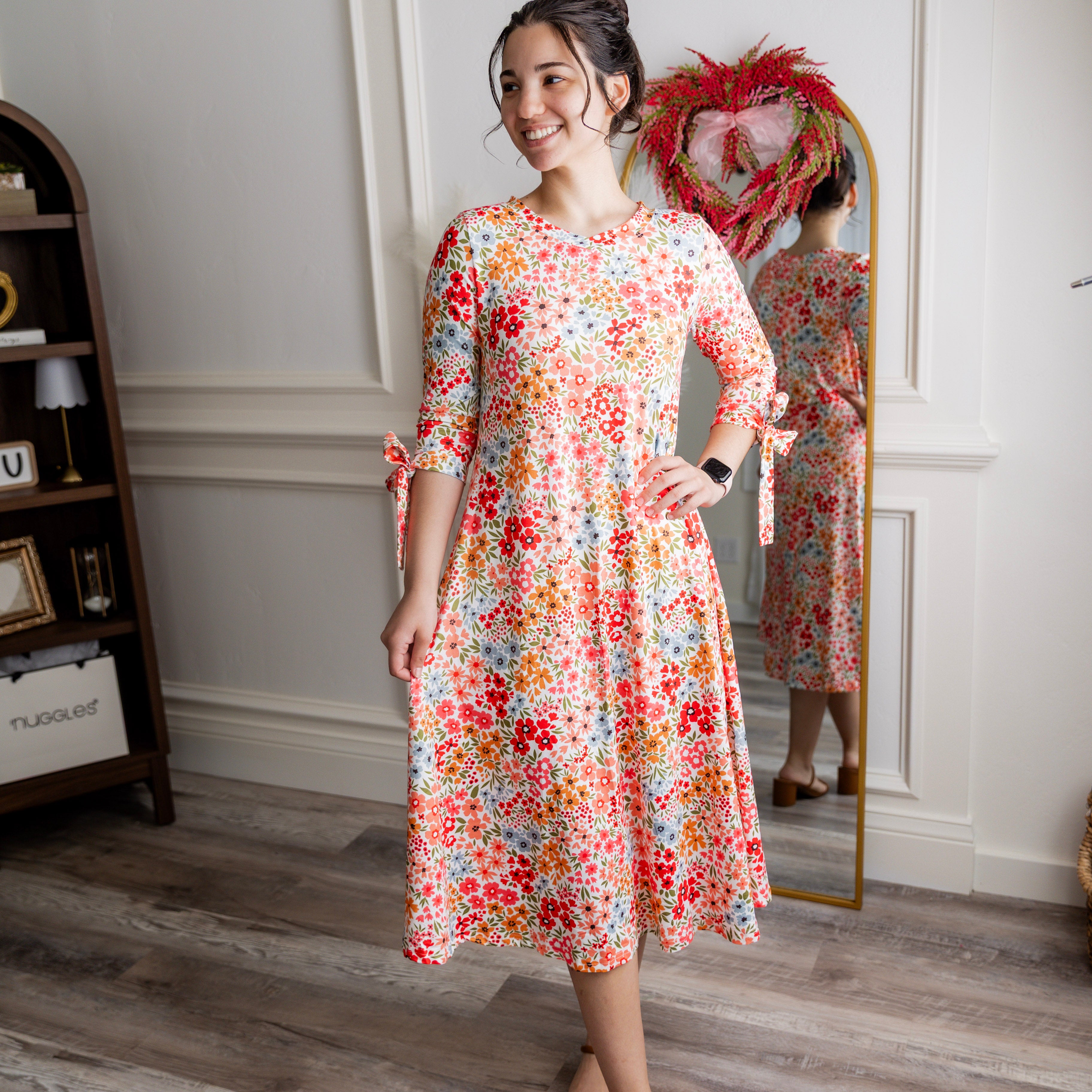 Model wearing the Nuggles® Hazel Dress in Confetti Garden Bloom floral print modest boutique dress