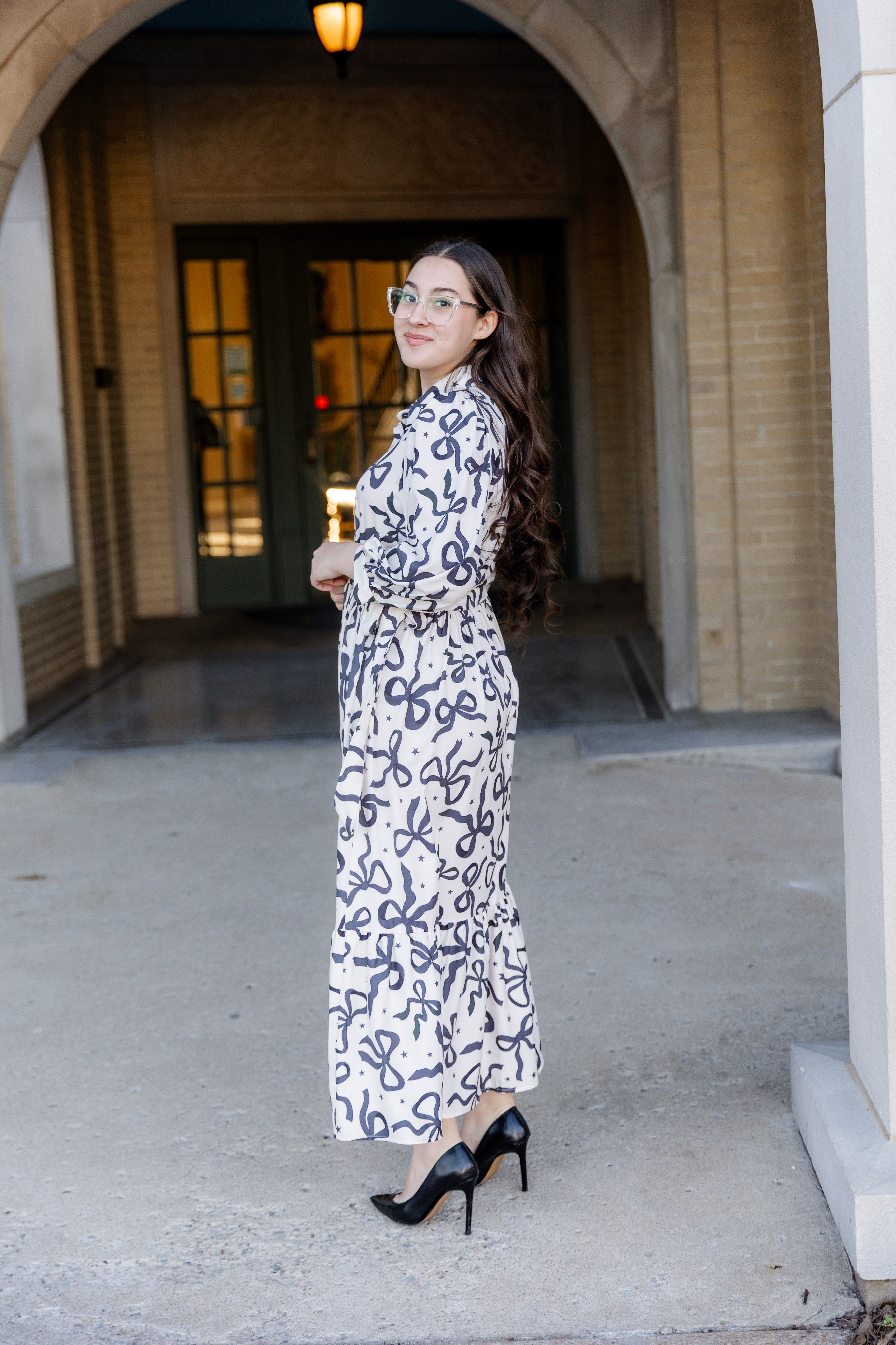 Model wearing the Nuggles® Leila Dress in Bow & Tell