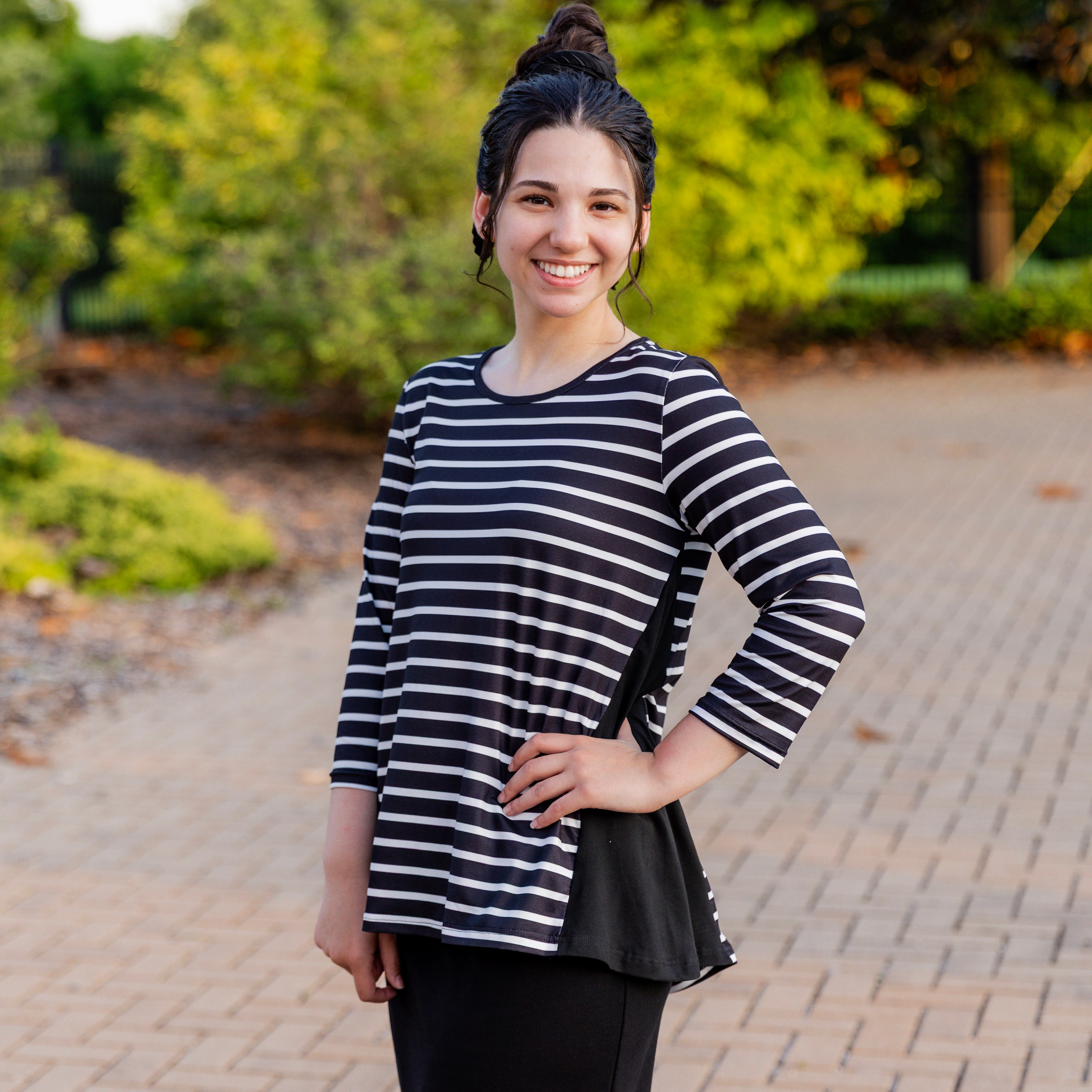 Model wearing the Adrielle Top with 3/4 sleeves and a classic skirt – modest women's top from Nuggles®