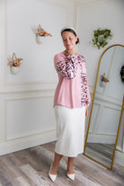 Model wearing the Nuggles® Harlow Top with red and navy color block design.