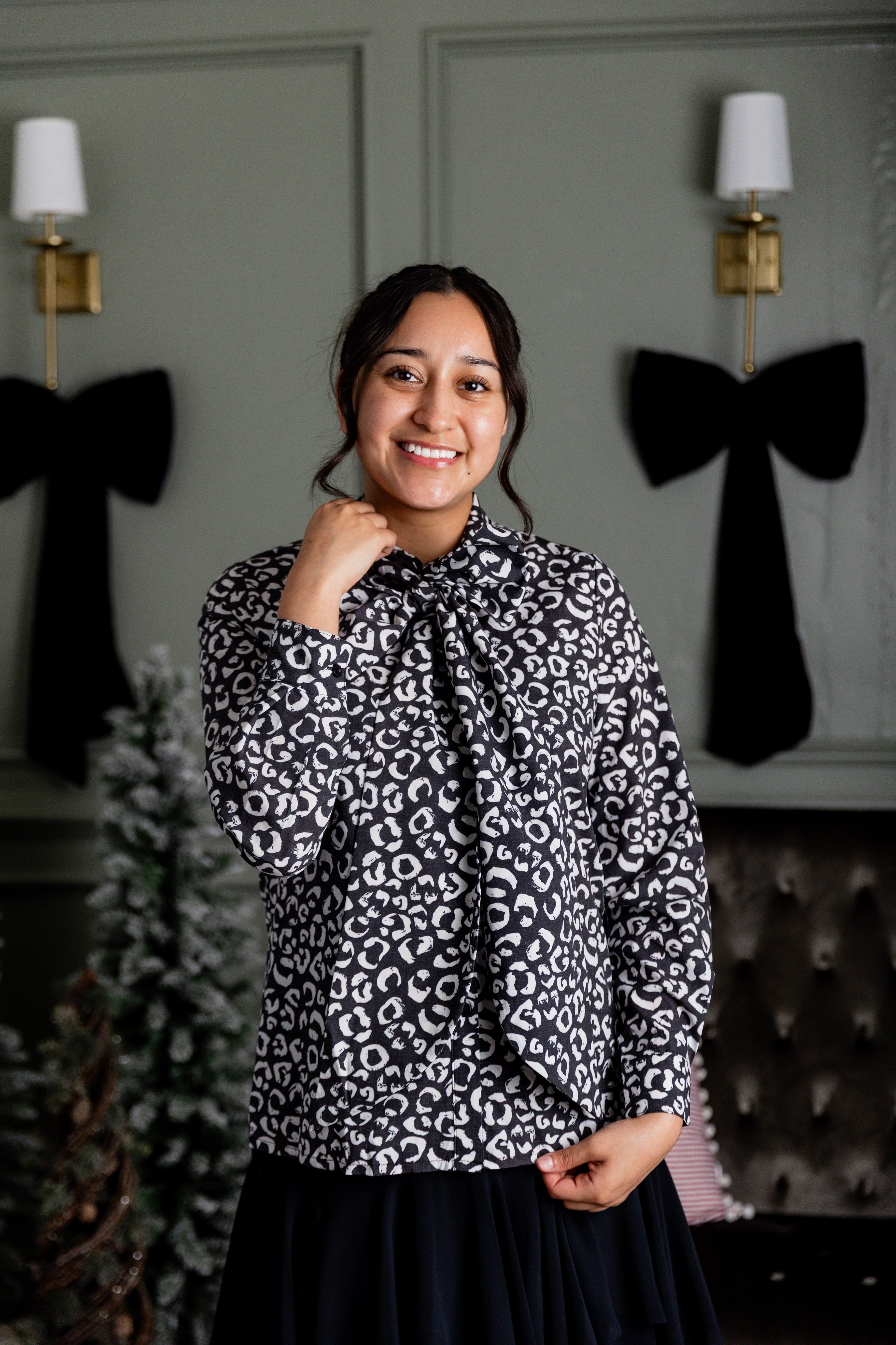 Model wearing Nuggles® Felicity top with large bow tie neckline, modest women's blouse.