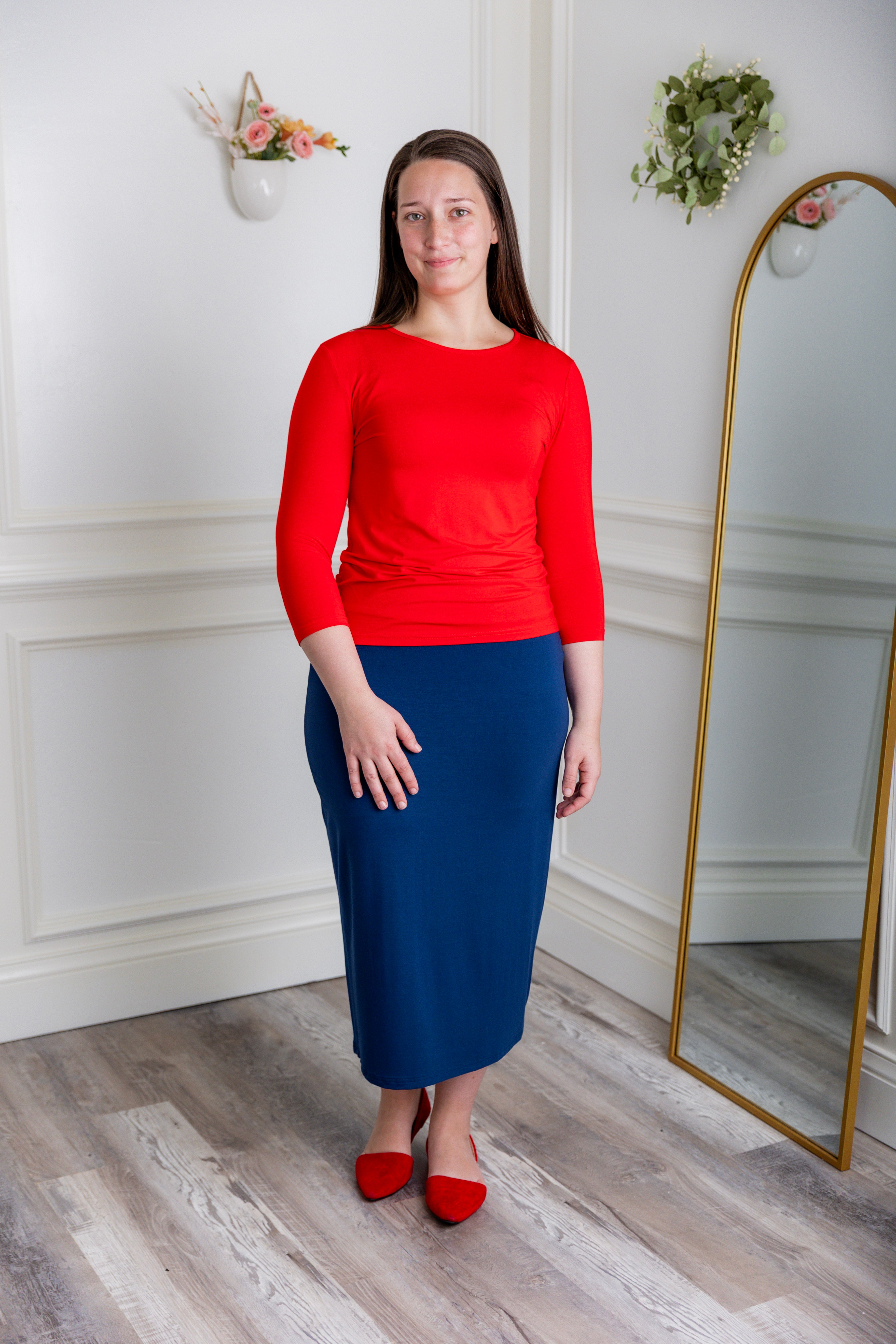 Model showcasing  Nuggles® midi tee skirts in various solid colors, modest 27" and 31" lengths