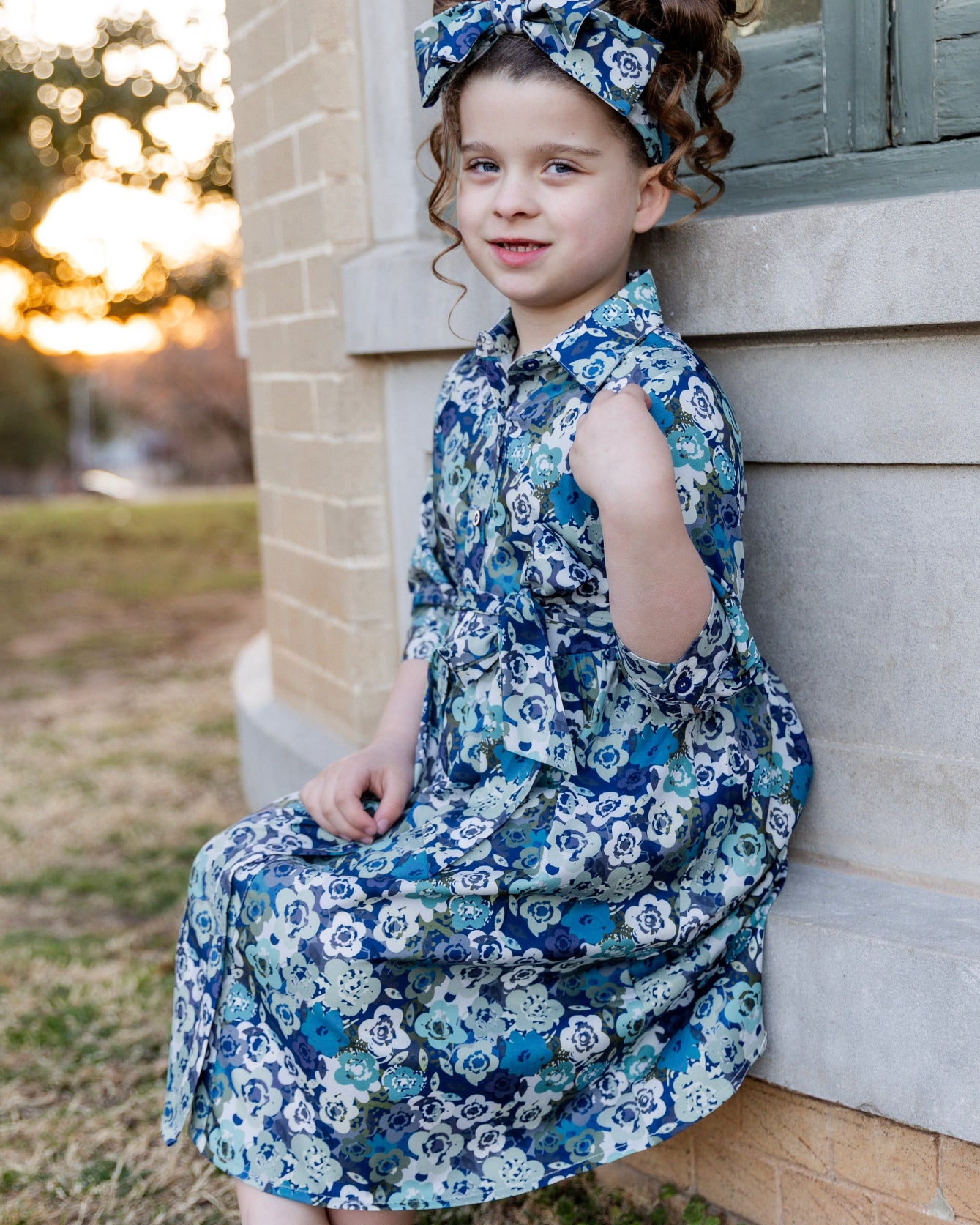 Model wearing the Nuggles® Girls' Rachel Dress and matching Headband in Storm Brush